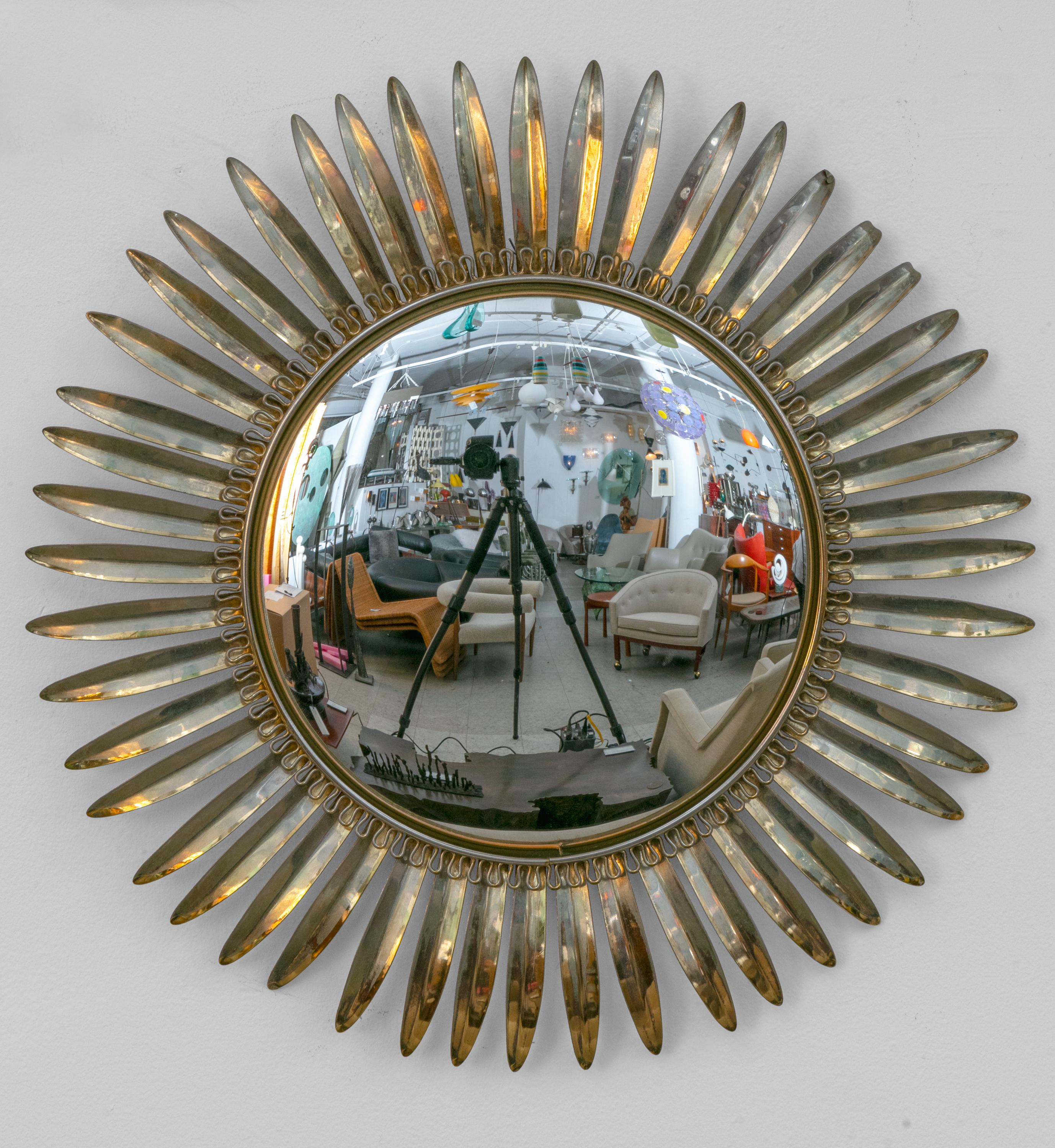 A pair of quintessential midcentury starburst mirrors with a decorative border surrounding the mirror.