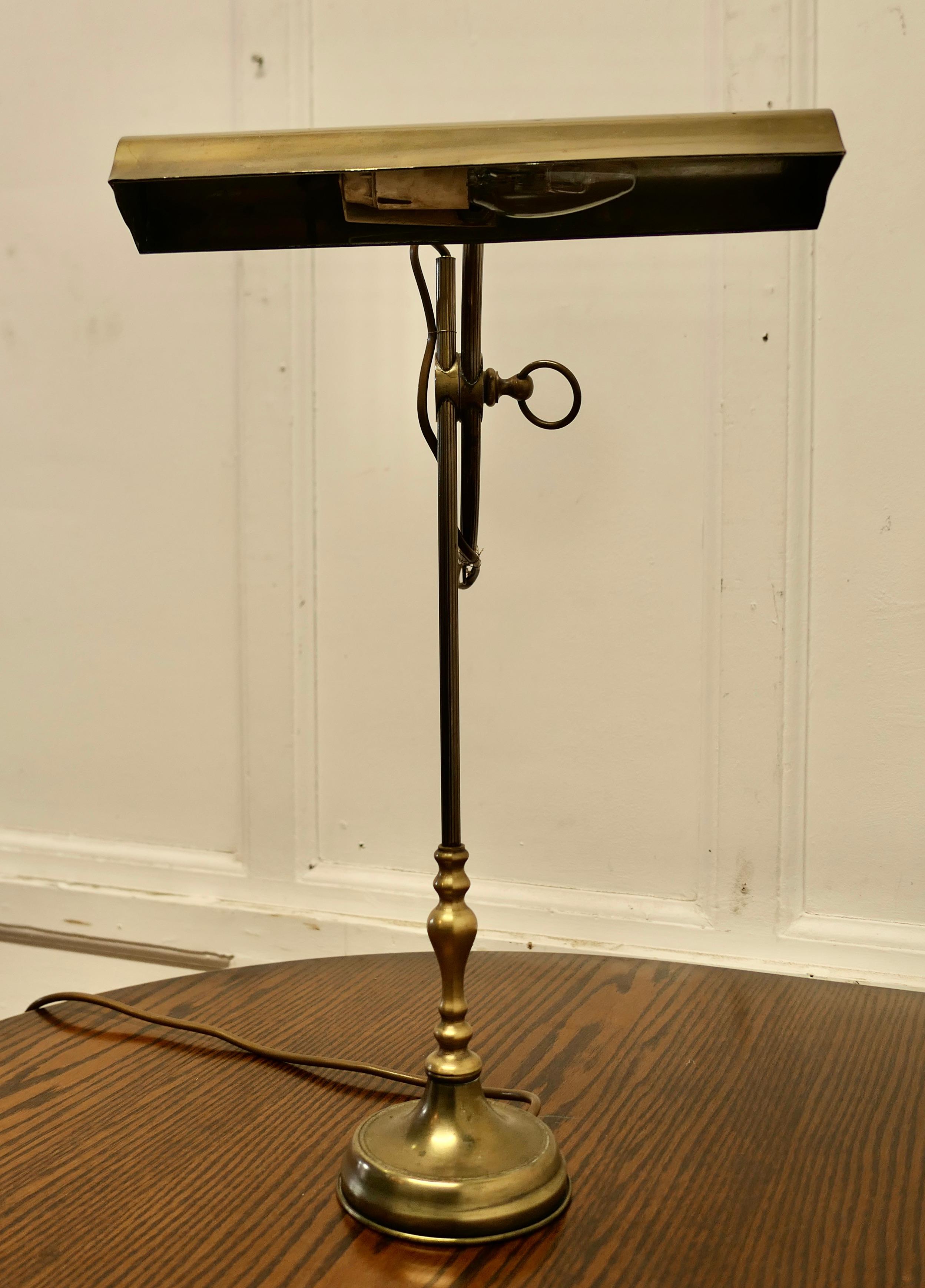 Early 20th Century French Brass Desk Lamp with Long Brass Shade  This is a very attractive piece