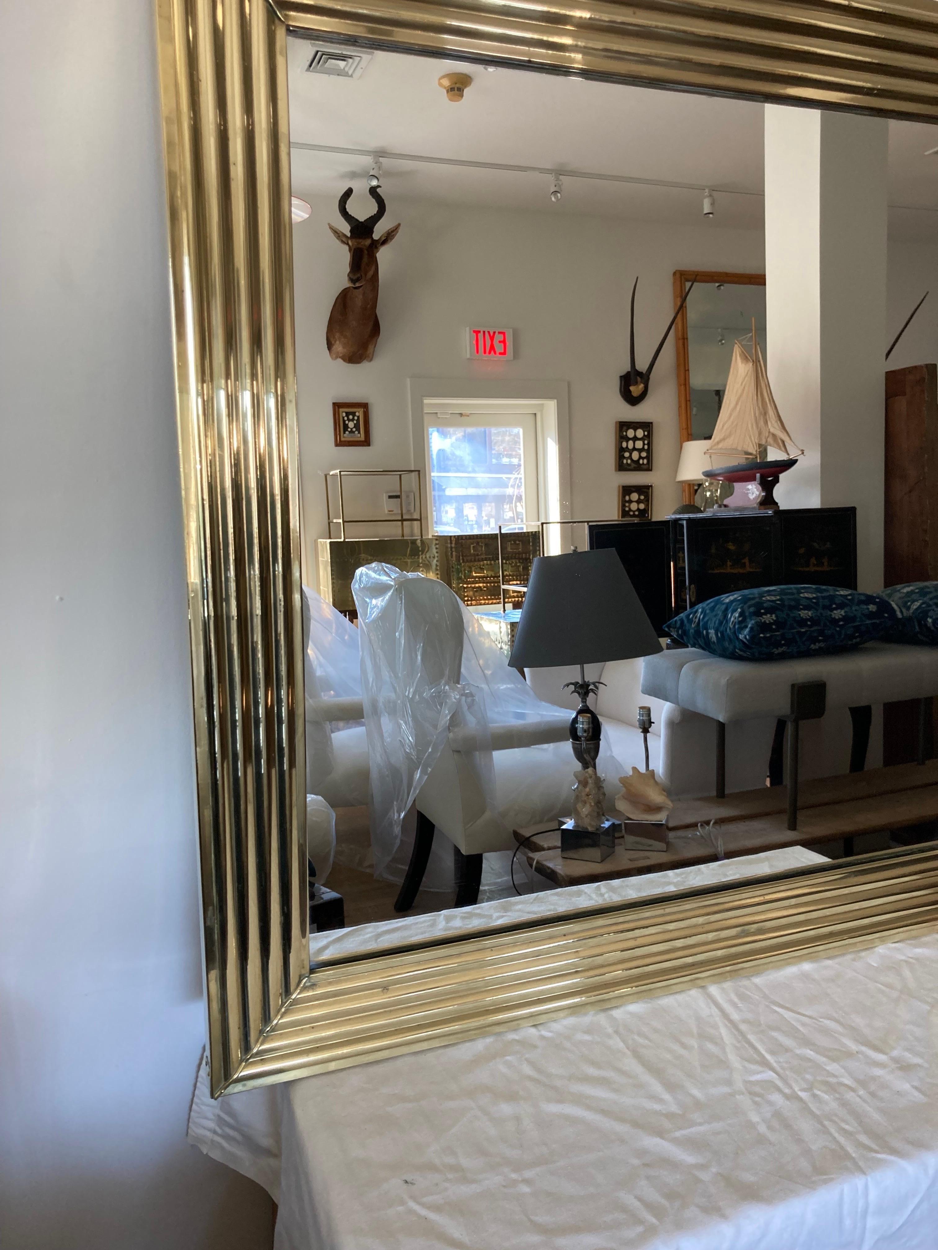 Almost square 39 x 39.25 brass framed bistro style mirror.