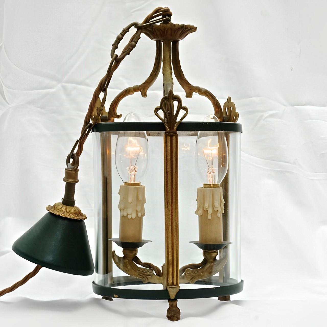 Round glazed two light French green painted lantern, with a decorative brass design. The glazed part of the lantern is height 18.8cm / 7.4 inches, and the lantern top is height 10cm / 4 inches. Diameter 14.8cm / 5.8 inches The lantern has been