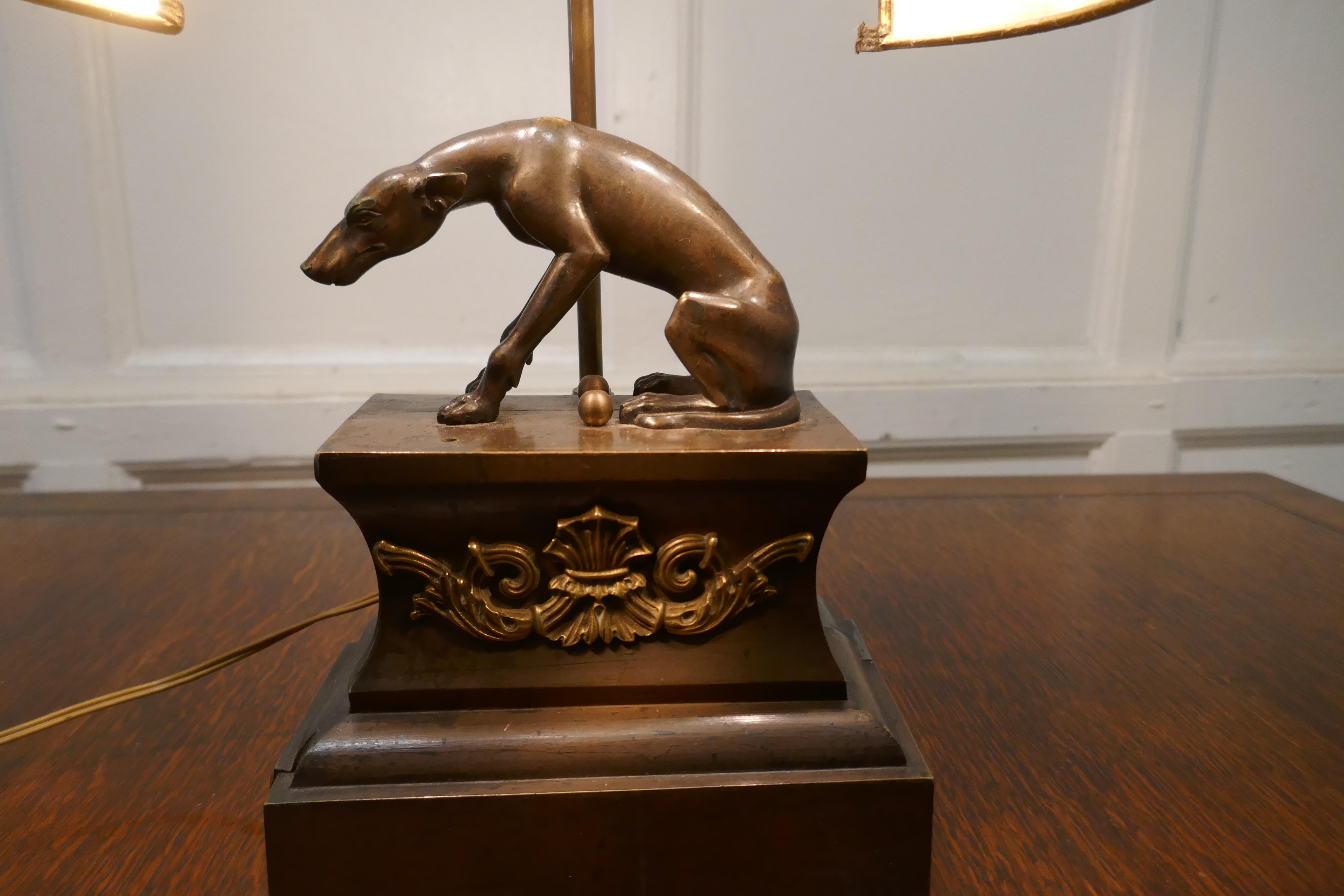 French brass greyhound statue lamp

A handsome piece made in Brass and Iron with a bronzed finish to the dog
3 Dimensional and looks great from all sides, the shade of this lamp has a metal look, it is parchment 
The Lamp is 17” high, 13” long