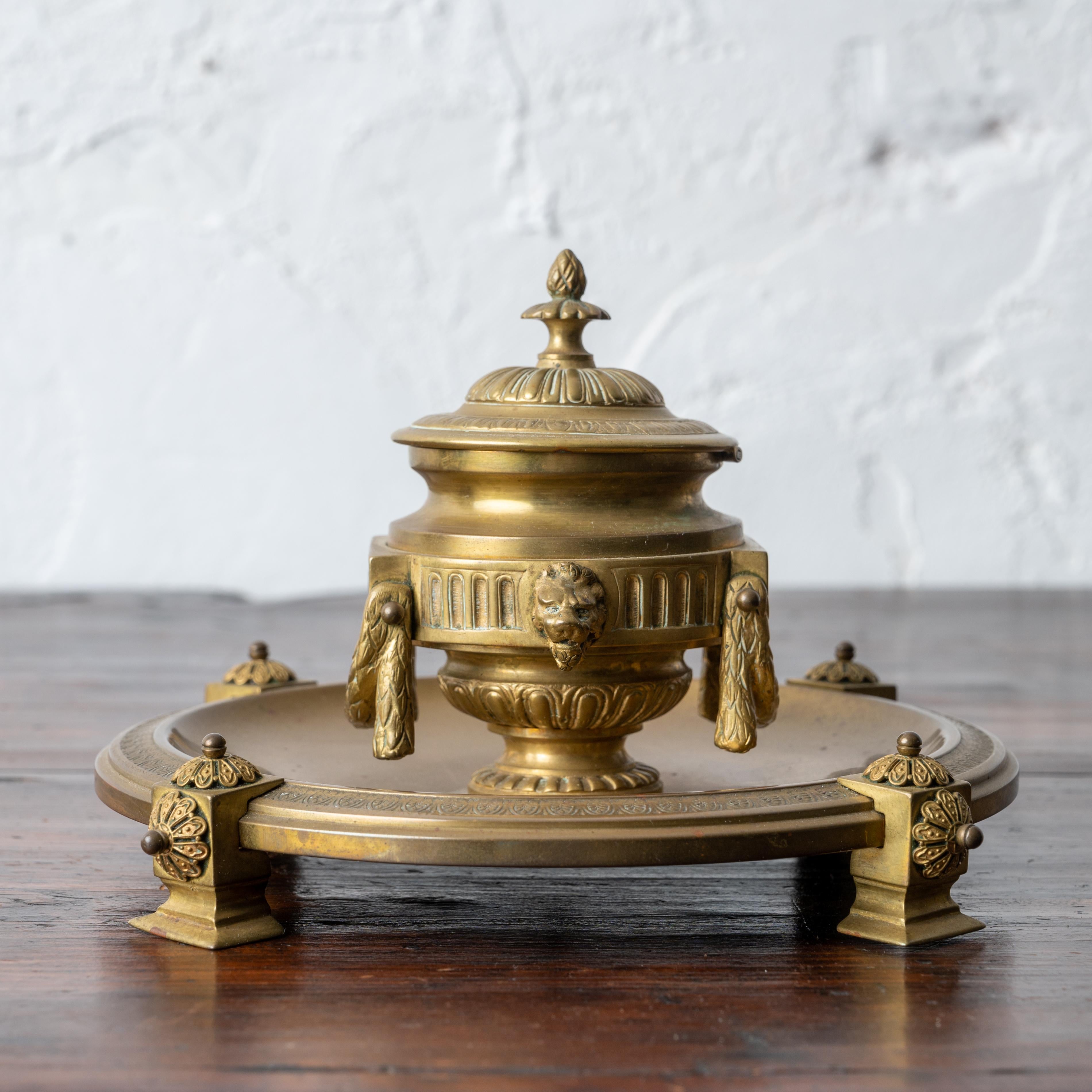 A French brass inkwell, 19th century.

8 ¼ inches wide by 4 ¾ inches tall

