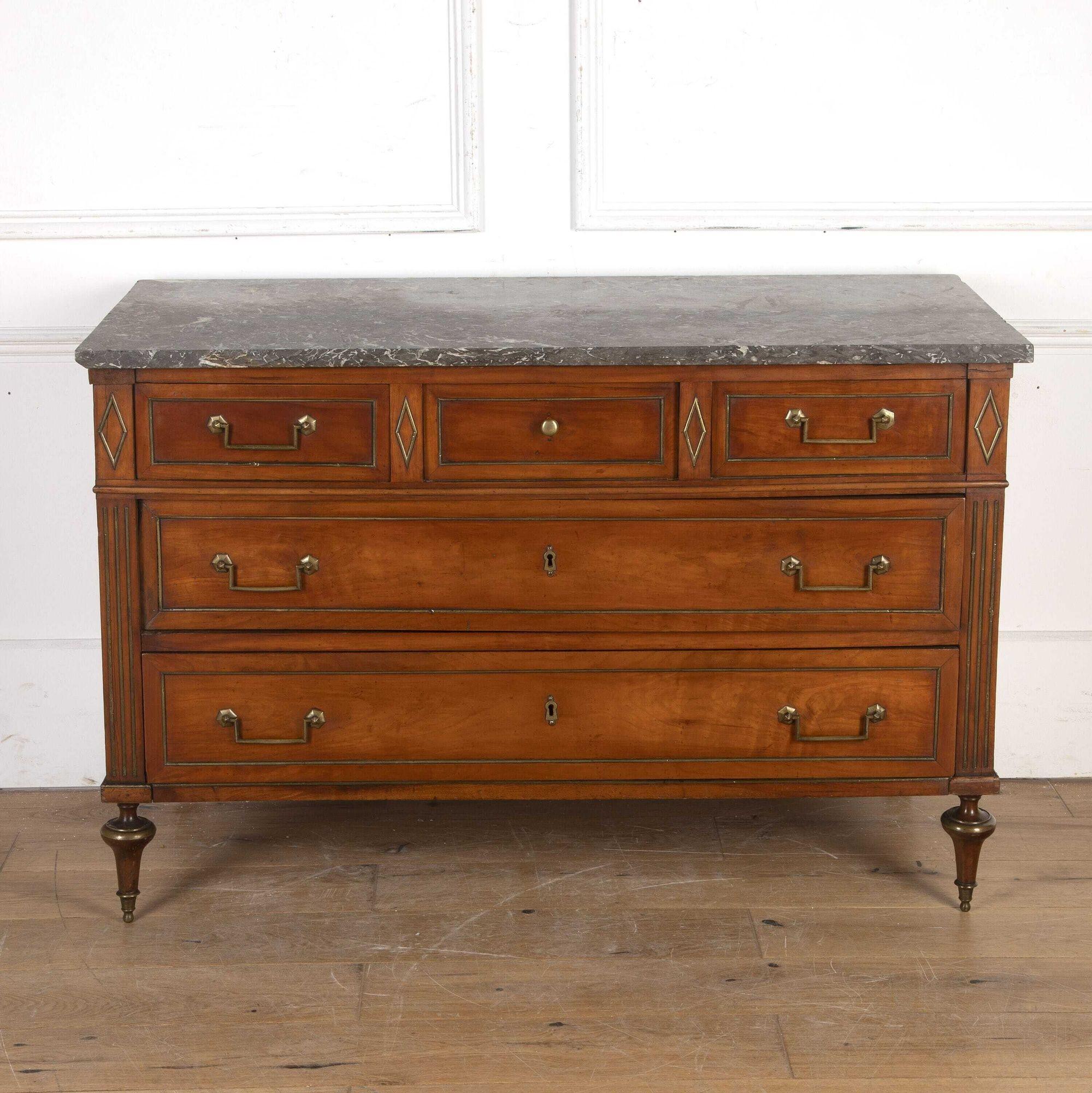 Beautiful French 19th century cherrywood commode in the Louis XVI style.
This commode has a very refined and elegant rectilinear profile and exhibits beautiful colour and patina throughout.
The nicely figured grey marble top sits over an