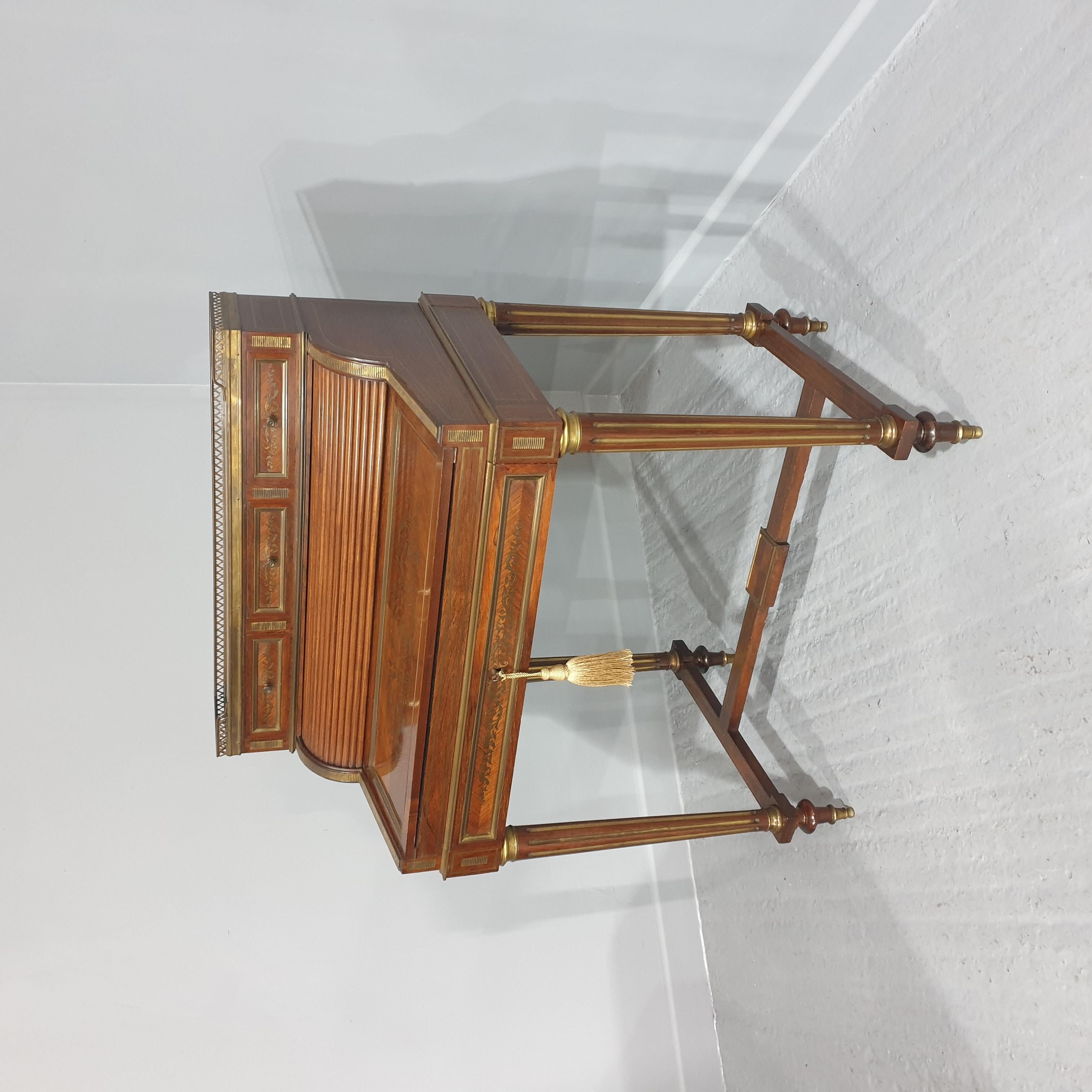 A top quality French rosewood brass inlaid desk, with tambour front, you have to pull open the drawer to release the tambour and then fold over the original velvet writing surface, lovely marble top with brass gallery, six opening drawers and pigeon