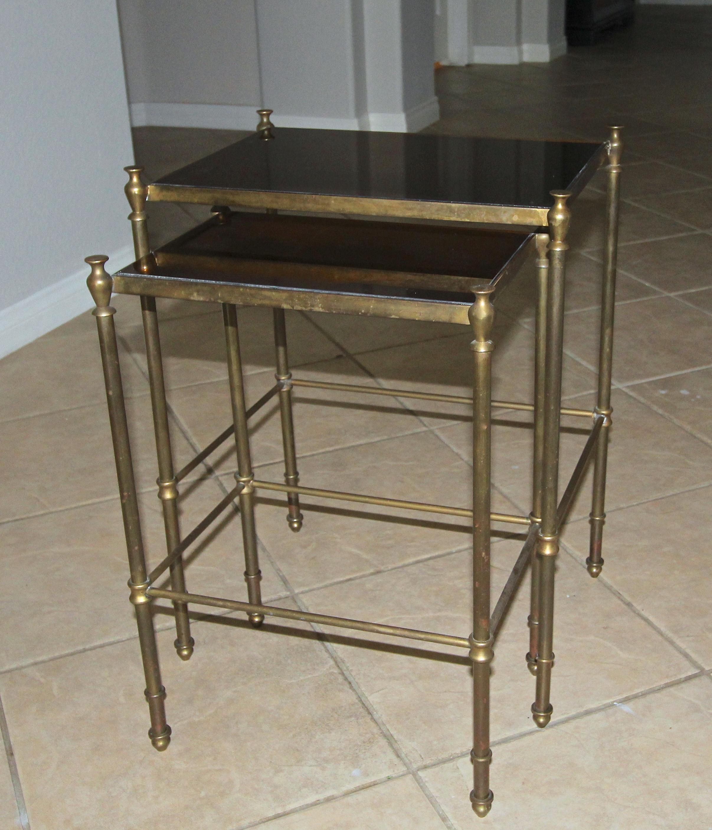 Pair of brass or bronze nesting tables with antiqued bronzed mirrored inset tops, can be used as side table. Nice bronzed aged patina to brass finish.

Table #1 - 16 W x 12