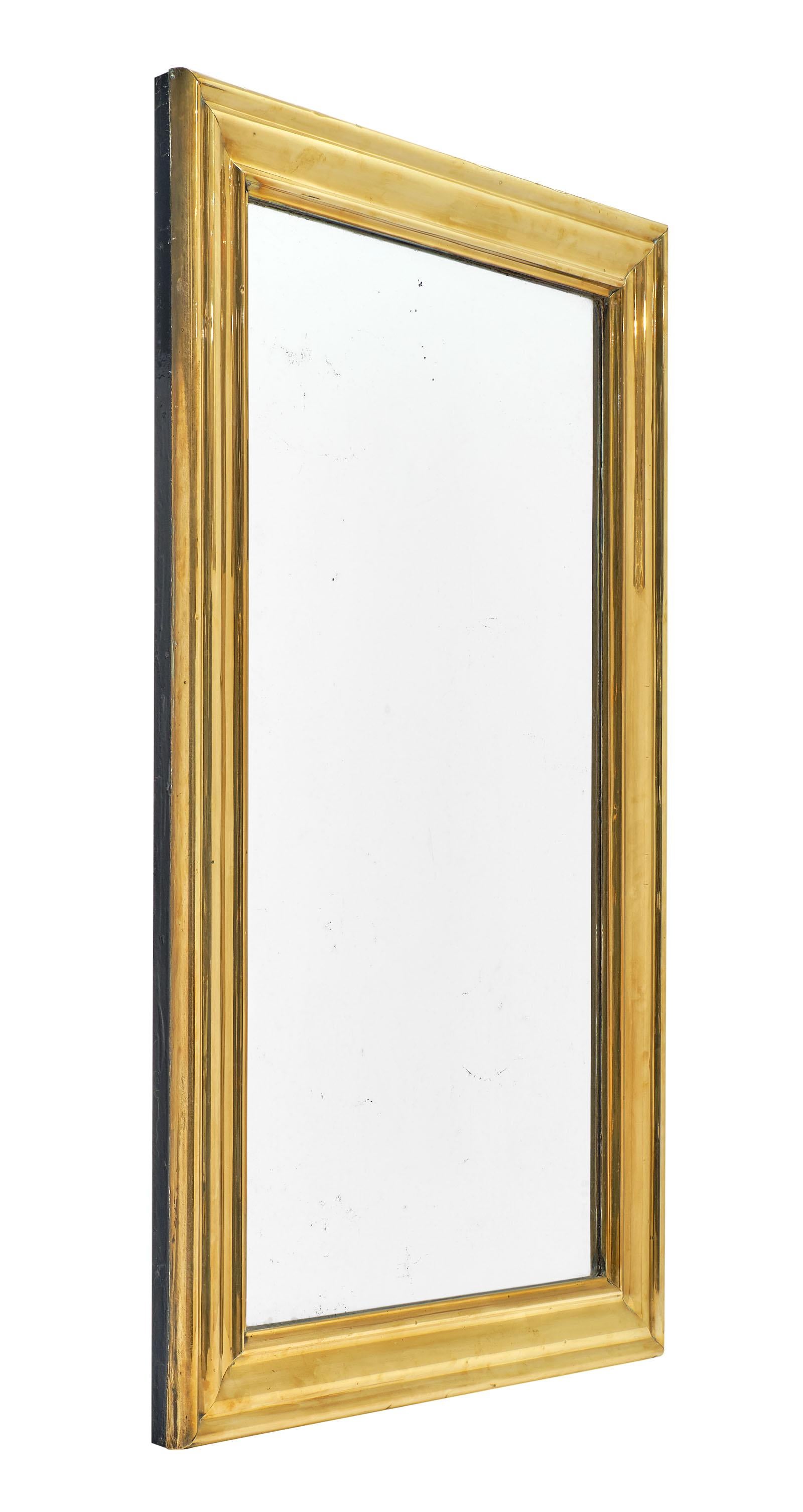 French Napoleon III mirror of wood with a frame lined in a sheet of molded brass. The mercury mirror is intact and original.