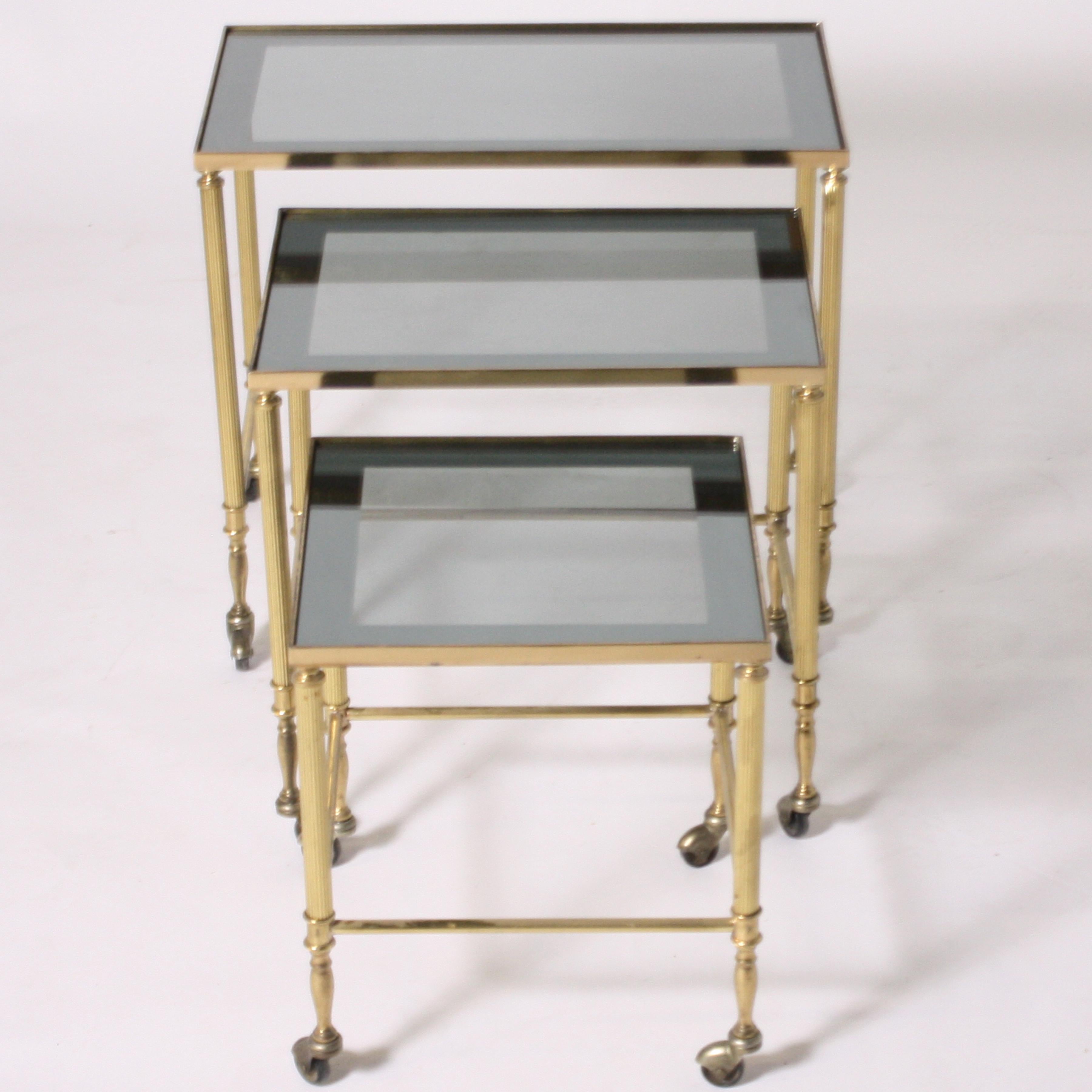 French brass nesting tables with wheels, circa 1950.