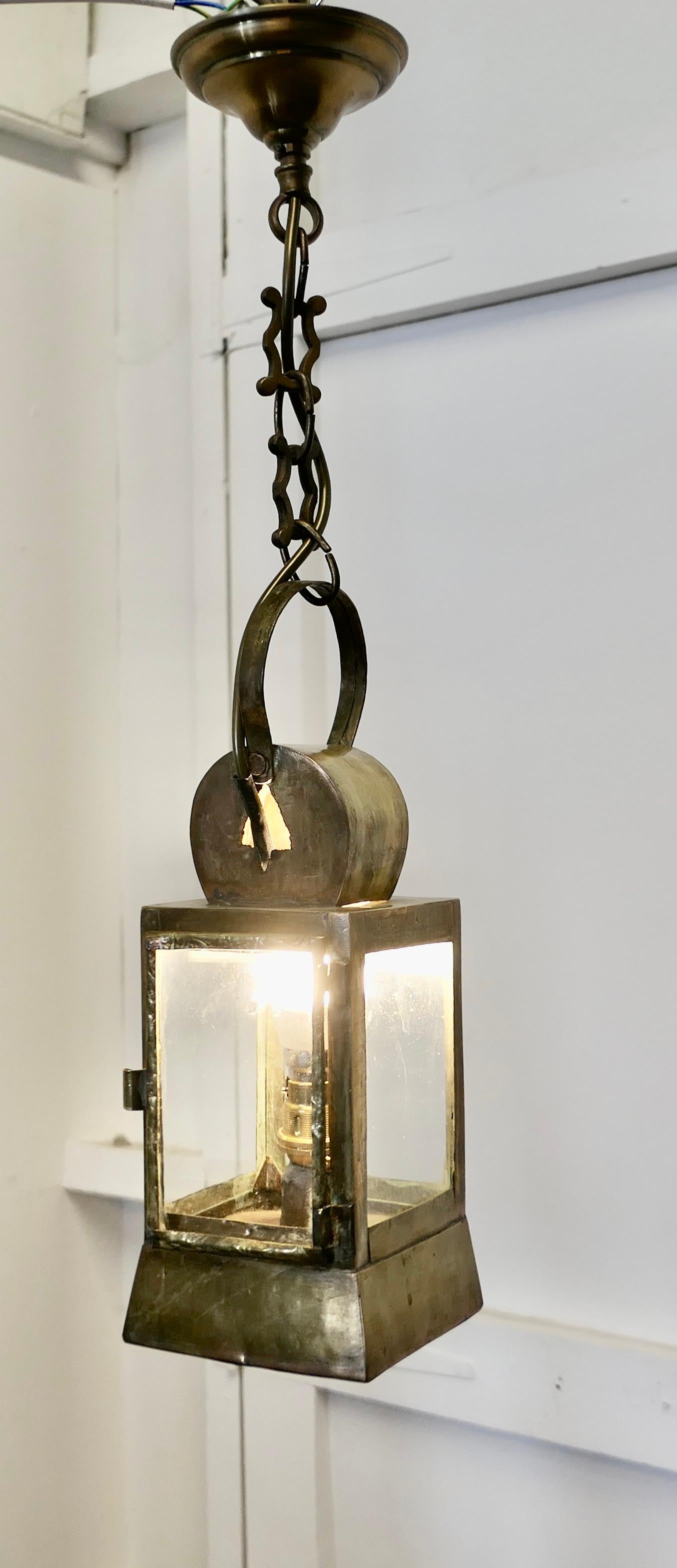 French Brass Night Watchman’s Lantern

This is a lovely piece, originally an oil lamp, it has been given a new lease of life with the addition of electric wiring and a hanging chain
The Lantern is square in shape with a round handle, it is 5”
