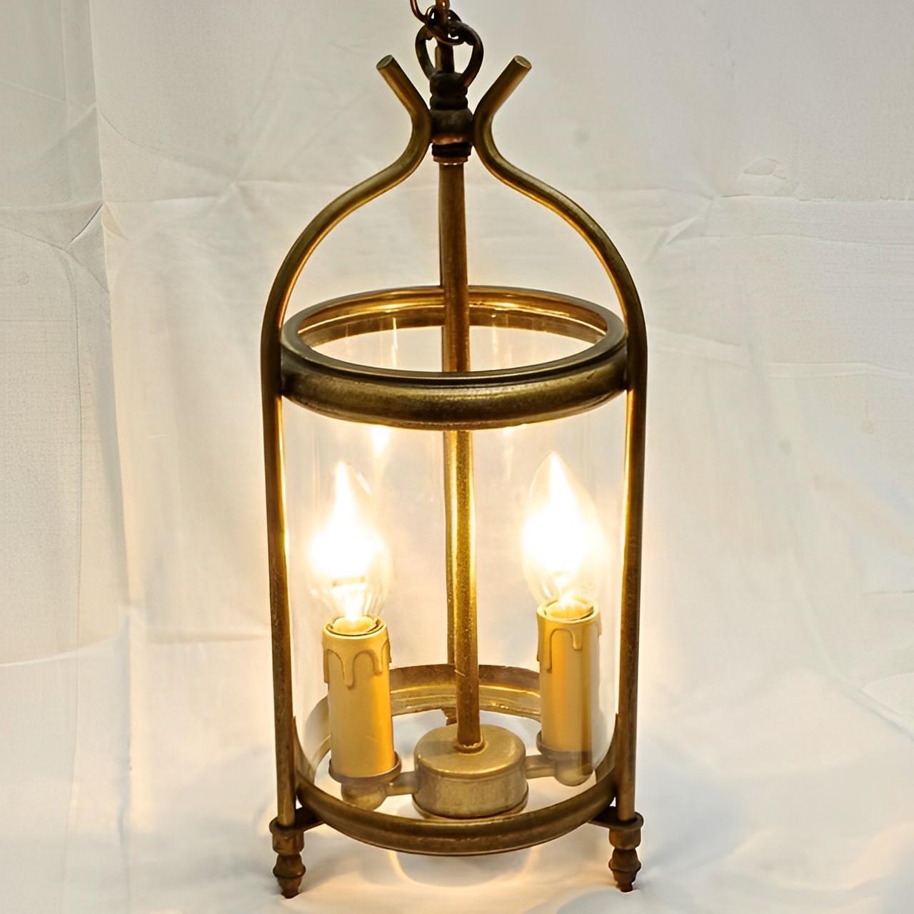 Round glazed two light French brass lantern in a stylish simple design. The glazed part of the lantern is height 24cm / 9.45 inches, and the lantern top is height 11.3cm / 4.45 inches. Diameter 15.1cm / 6 inches. The lantern has been rewired for the