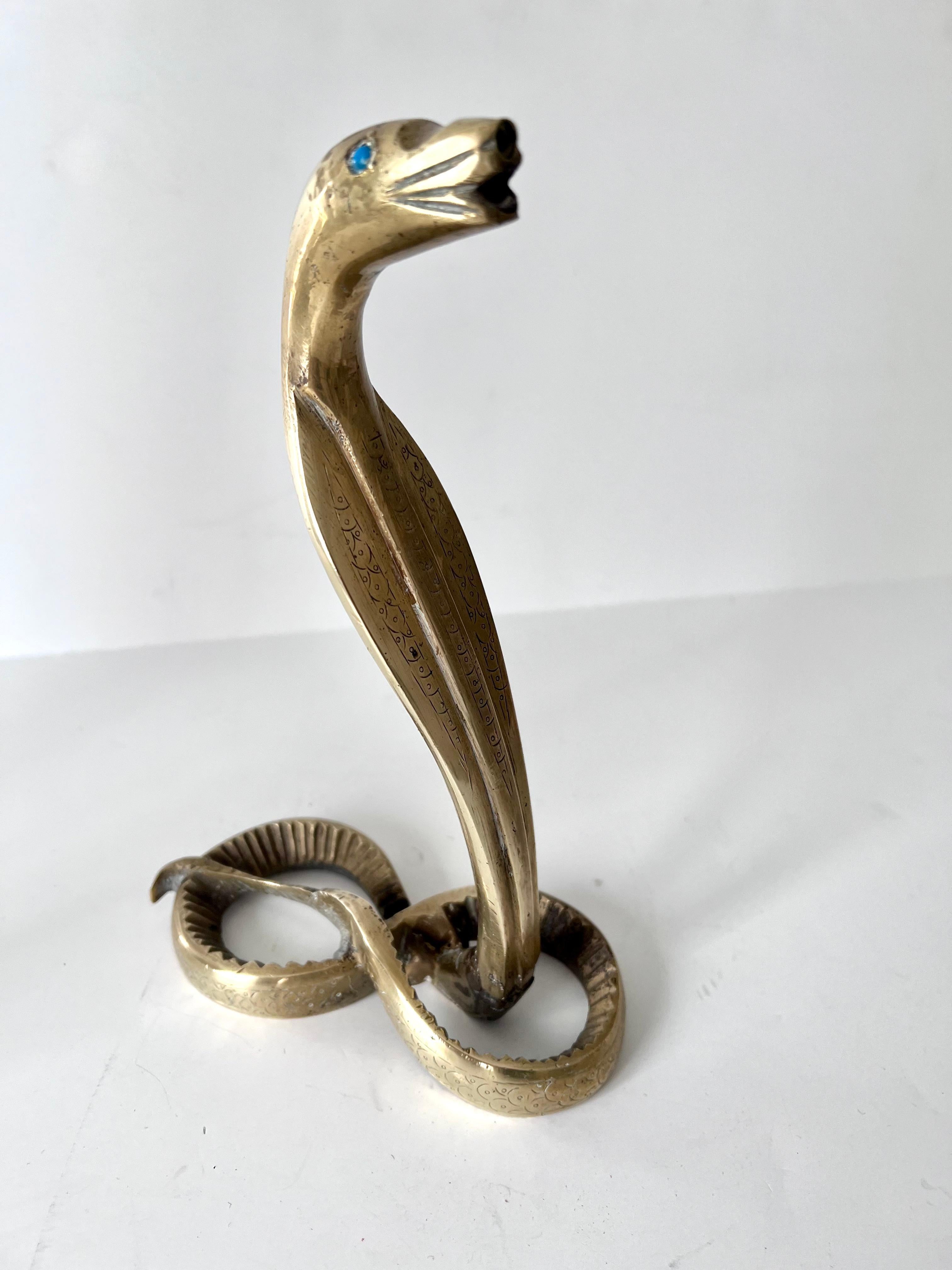 Acquired in Paris France, this serpent is a nice solid brass piece with turquoise or stone eyes.. whenever we have a snake they go fast, and this one should be no exception... a great piece, ready for any shelf as a sculpture or at a desk or work