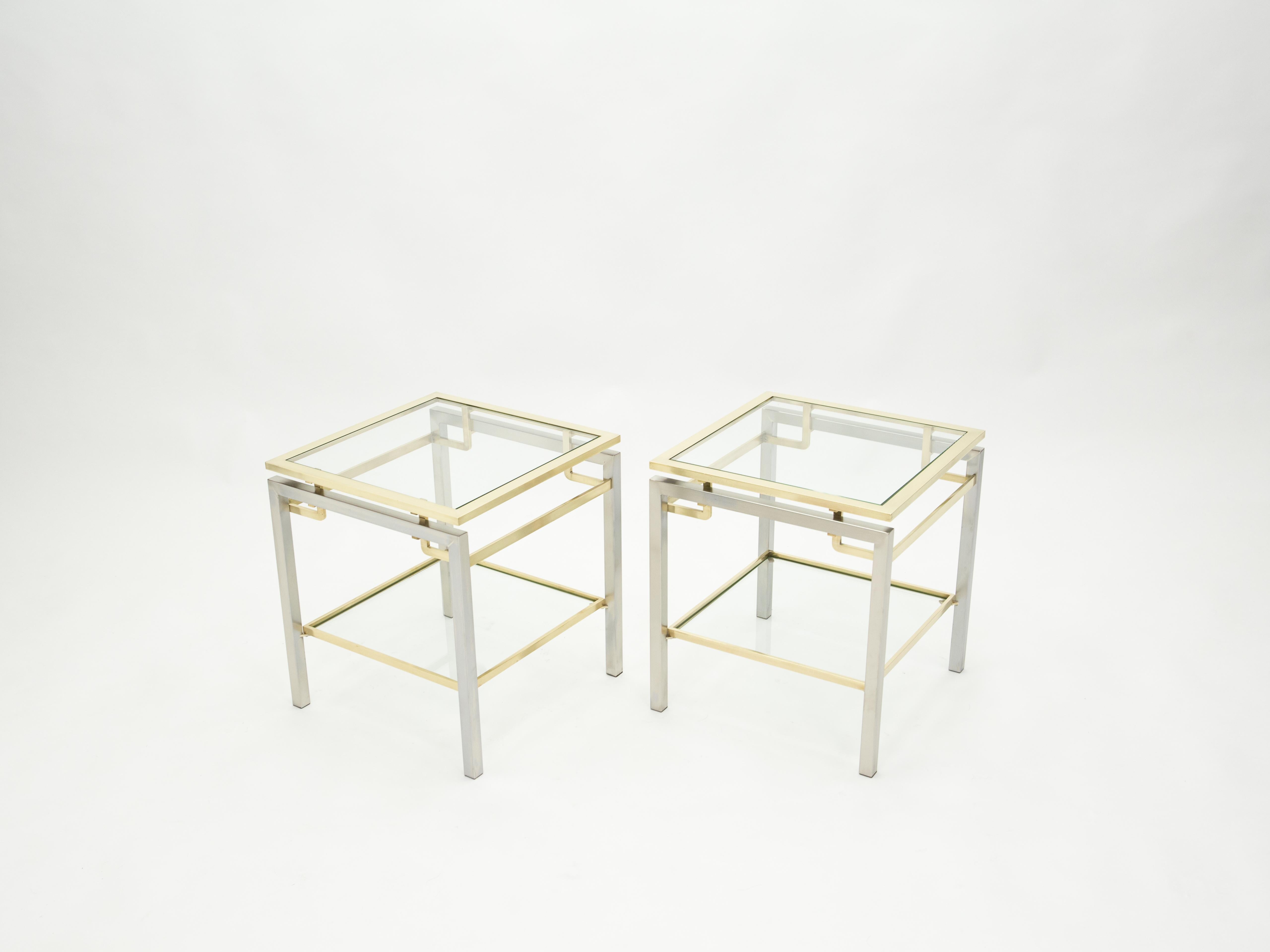 Simple lines point to these two-tier end tables French midcentury roots. Designed by Guy Lefevre for Maison Jansen, it features smooth steel legs with brass top and accents, and transparent glass tops. Its symmetry, elevated glass, and strong