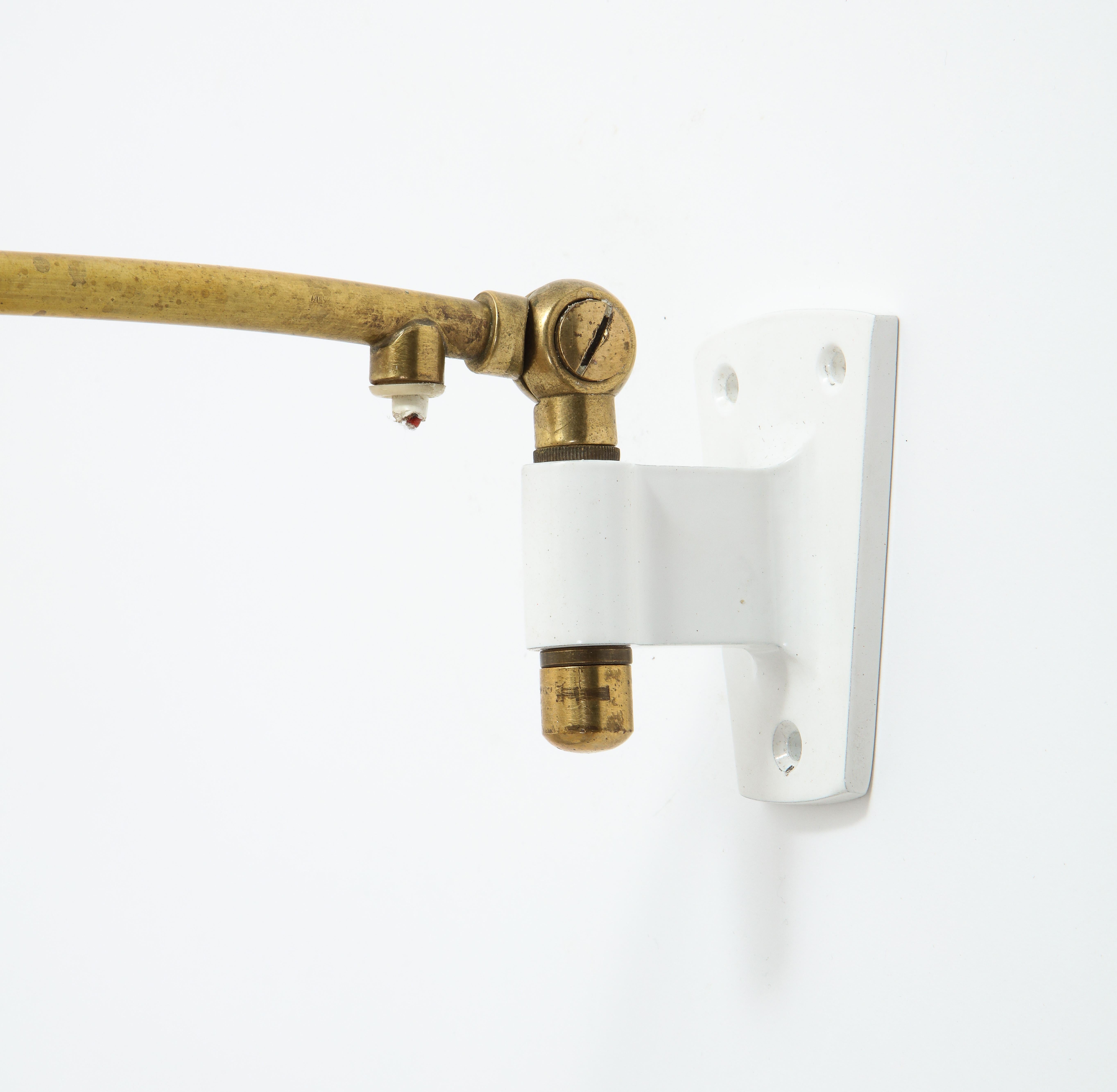 Petite brass swing sconce on enameled wall bracket, raffia shade. Rewired, width, and depth will vary with a different shade.