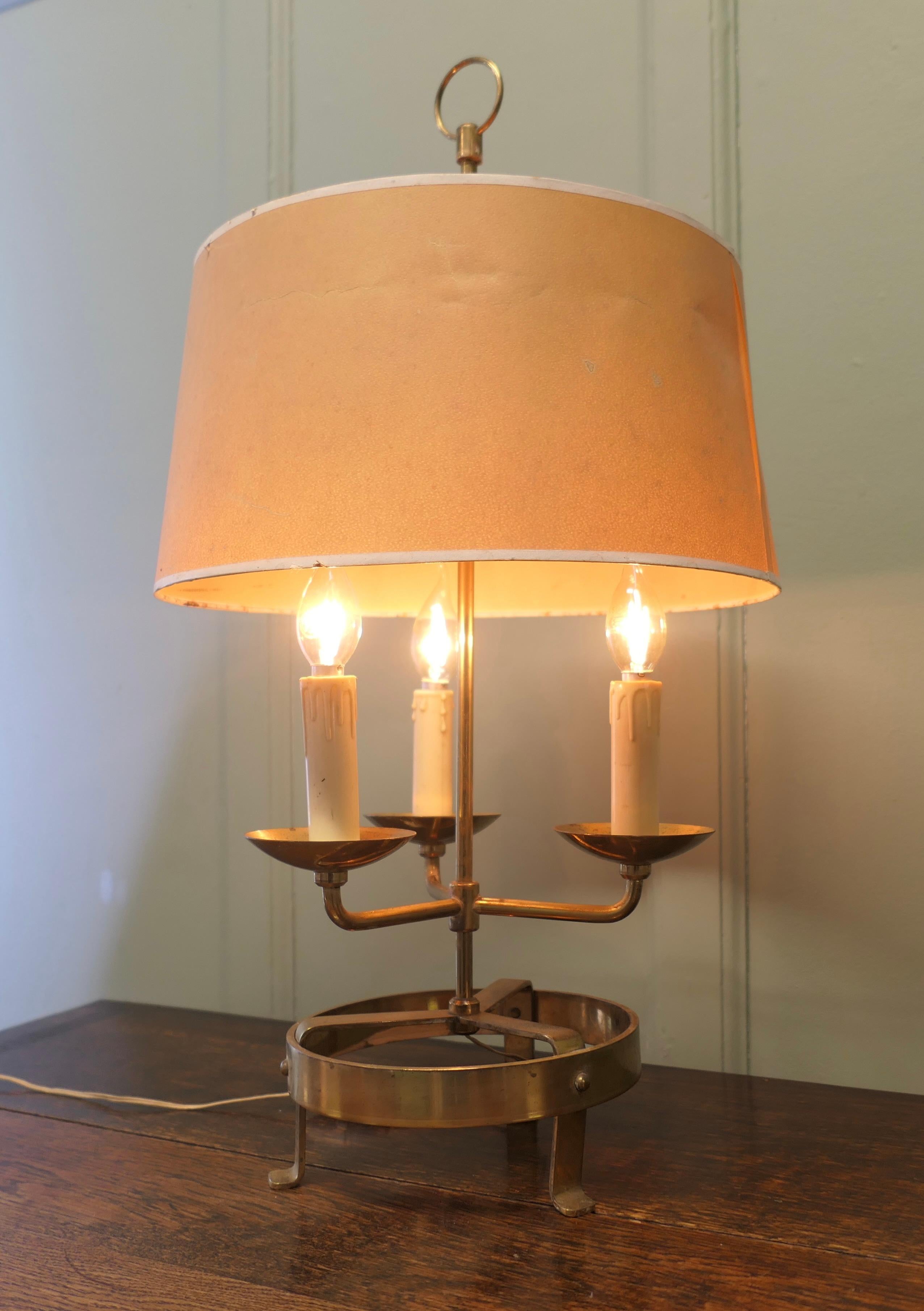 French Brass Table Lamp or Bouillotte Triple Desk Lamp

A lovely piece, a brass three sconce lamp with its original parchment shade 
A  Very traditional design with three candles, it is working and in good attractive condition  
The lamp is 26” tall