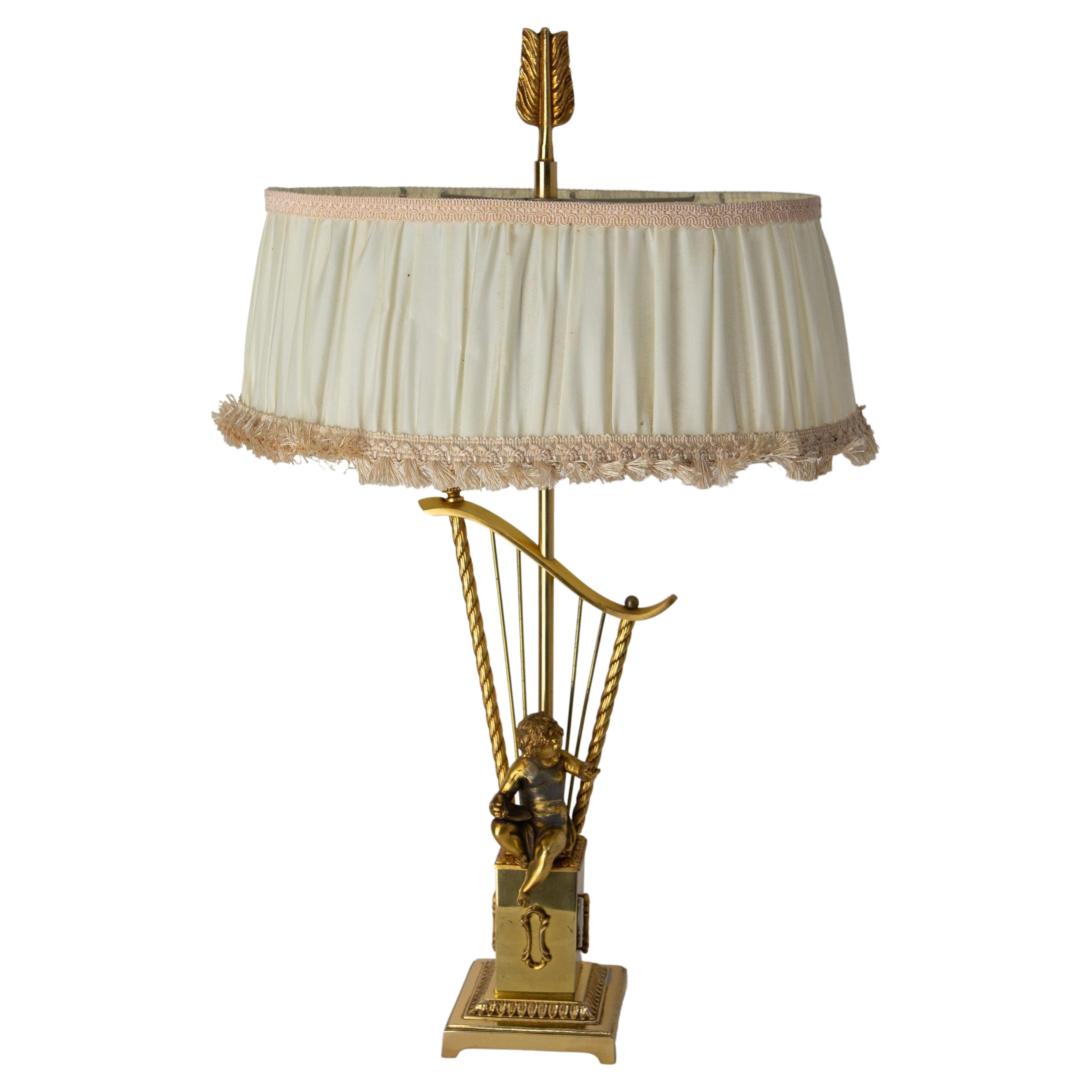 French Brass Table Lamp with Putti Reading in front of a Harp, Mid-Century For Sale