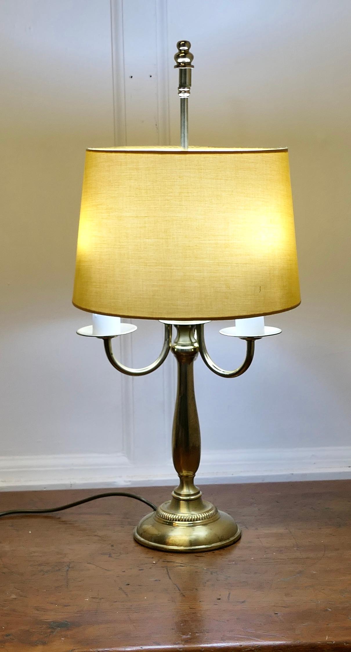 French Brass Triple Desk Lamp

A lovely piece, a brass triple sconce lamp this is a  traditional design the shade is in its original Mustard Gold
The lamp is all working and in good condition  
The lamp is 25” tall, 11” in diameter
TSW93