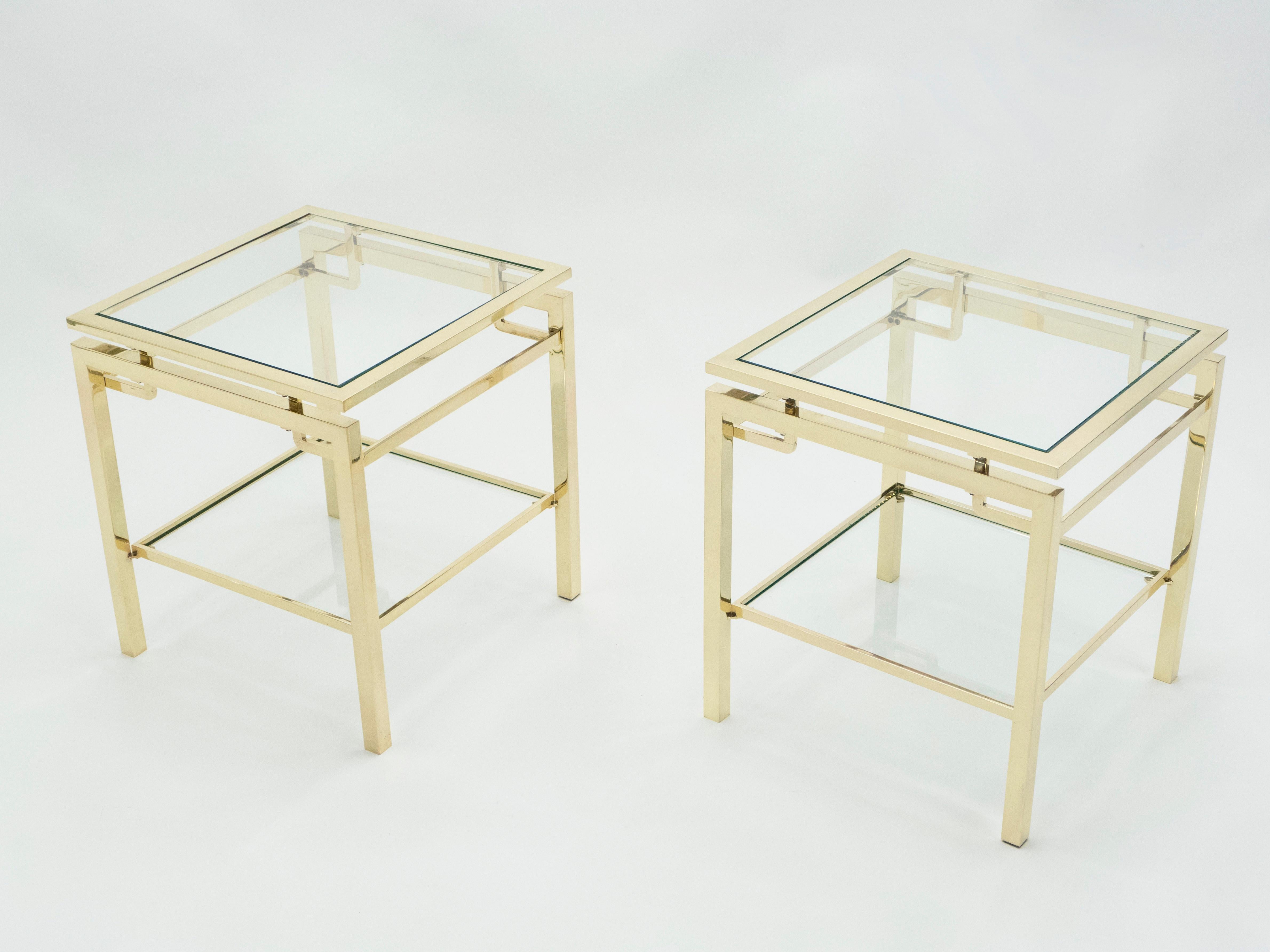 Simple lines point to these two-tier end tables French midcentury roots. Designed by Guy Lefevre for Maison Jansen, it features silky brass legs and transparent glass tops. Its symmetry, elevated glass, and strong architectural design combine to