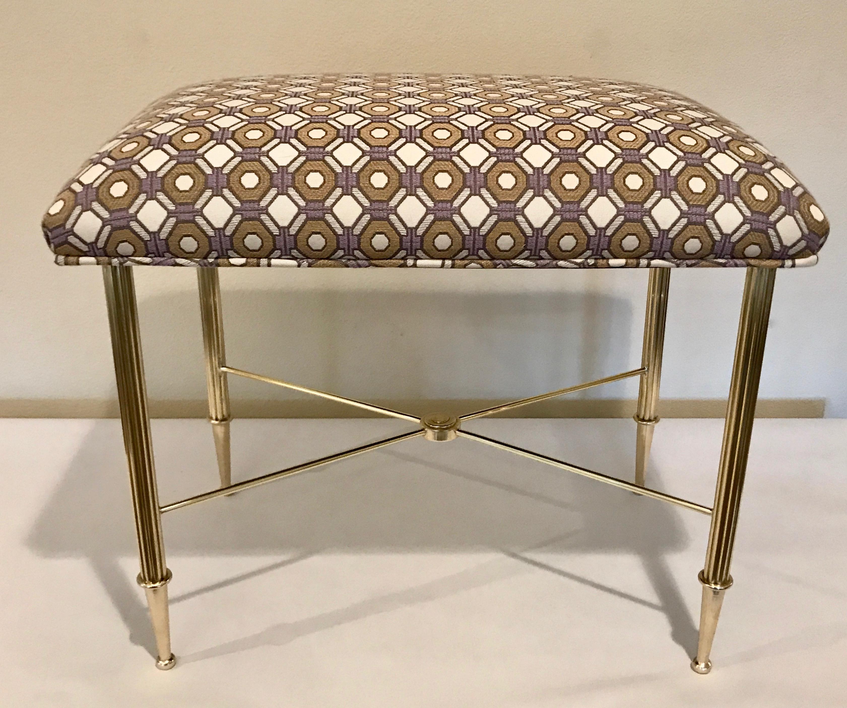 French brass bench or stool with reeded brass legs, stylized tapered feet and X cross bar with newly upholstered top.

Measures: 22