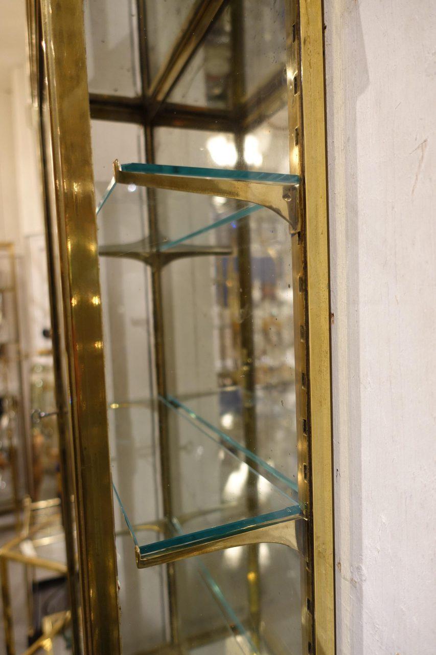 brass and glass wall cabinet