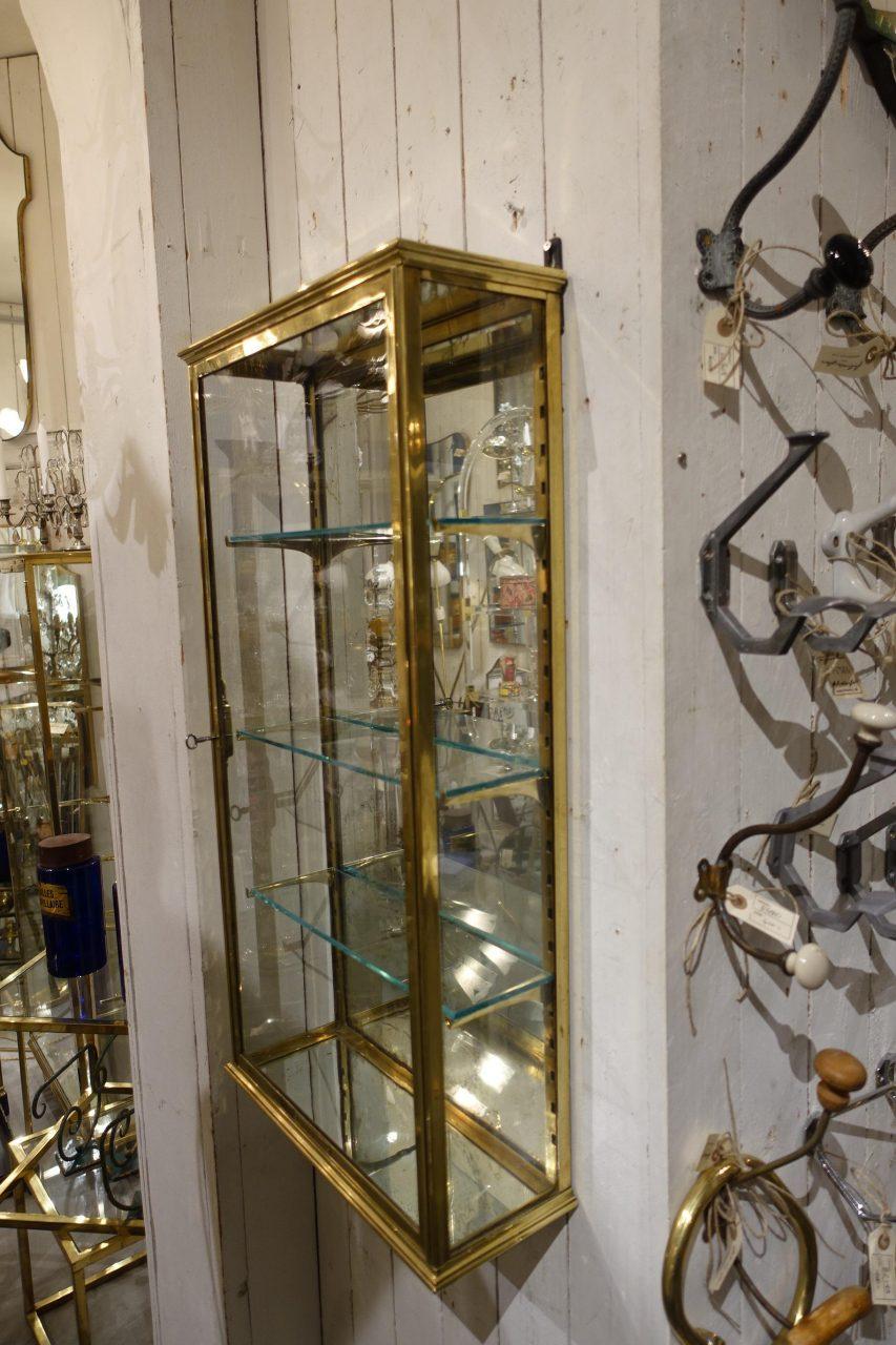 Elegant and presentable vintage French brass display cabinet /vitrine, from circa 1910s-1920s. 3 glass adjustable shelves. This showcase was originally boutique inventory, and is in super condition. The cabinet comes from a manufacturer in the