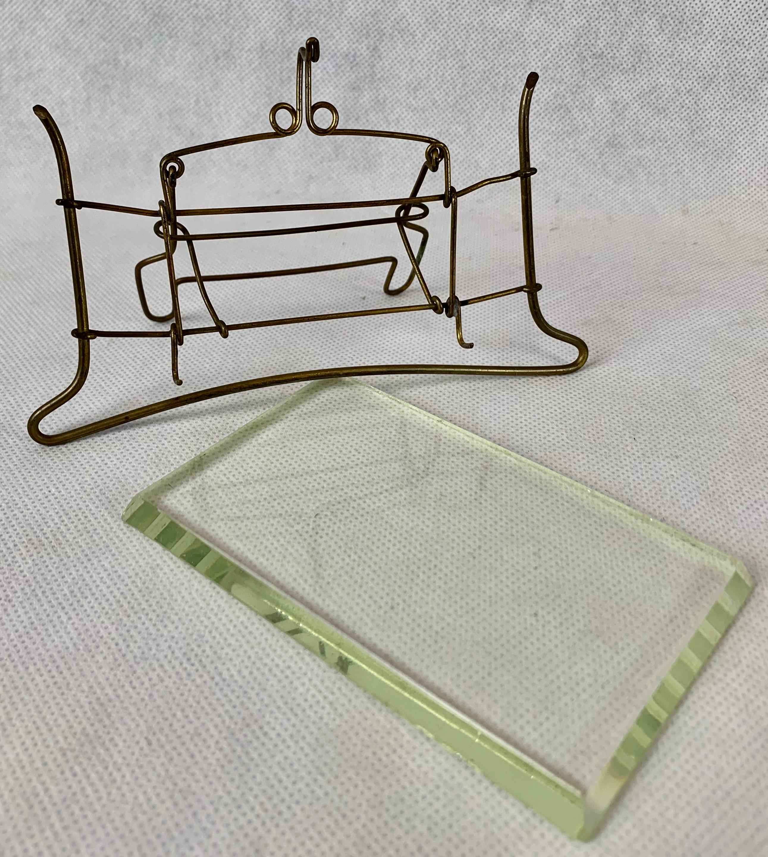 Unusual French brass wire and beveled glass photo frame. The design if this frame is so interesting you almost don't need a photo. It is very easy to use. You lift up on the top wire and remove the glass. Next you put your photo behind the glass and
