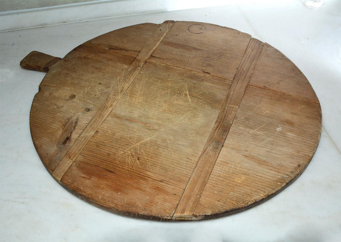 An early 20th century French bread or cheese board, excellent for serving cheese and crackers, charcuterie, or anything else your guests desire or displaying an assortment of treats.