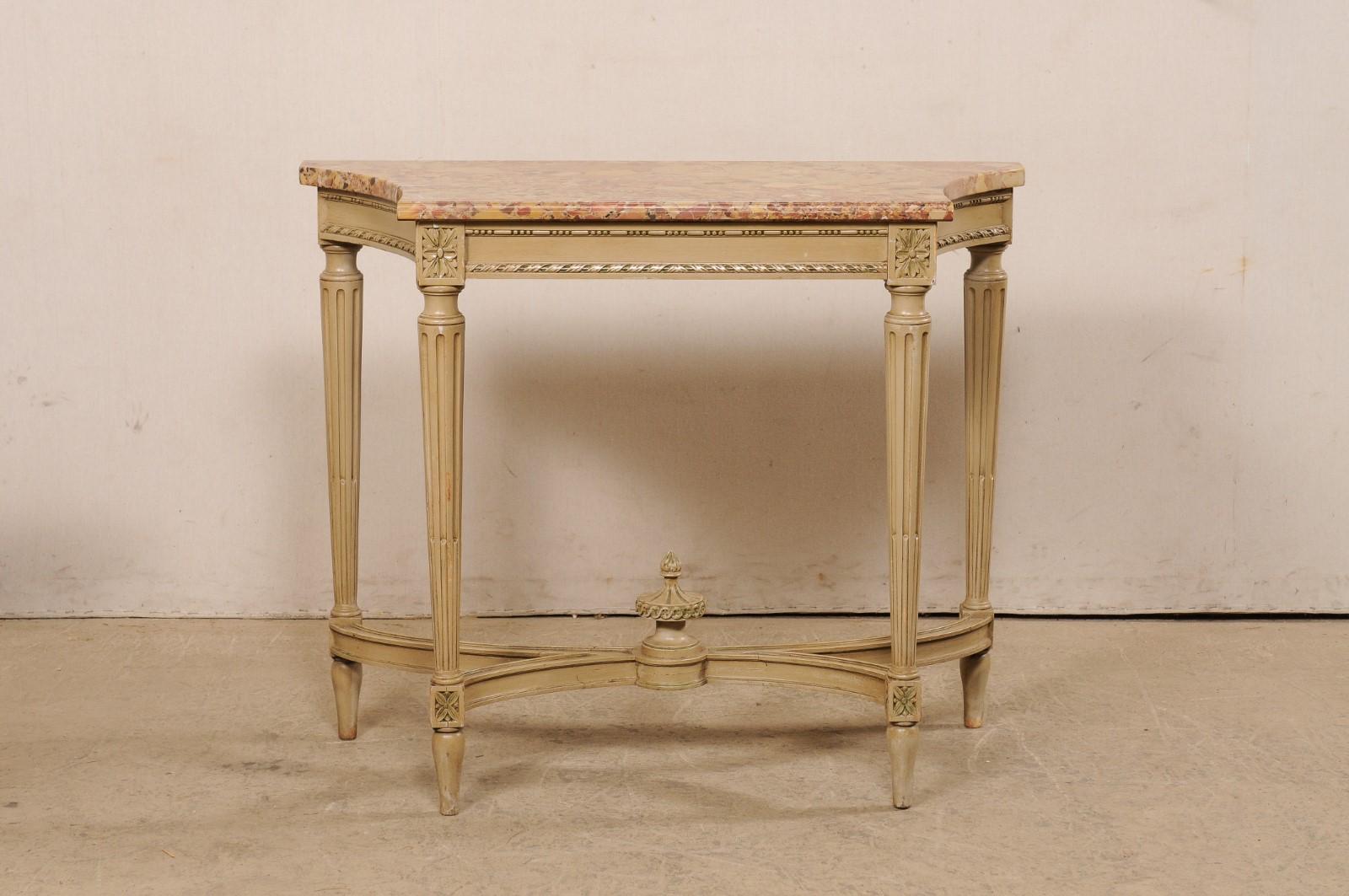 A French console table, with fabulous breche d'alep marble top, circa 1930s-1940s. This antique table from France features a breche d'alep marble top, comprised of a straight and shorter front side, with nicely scalloped & concaved sides, and longer