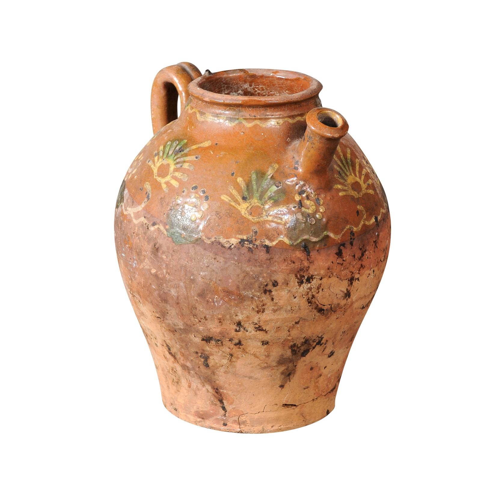 French Bressane pottery jug from the 19th century with brown glaze and soft yellow motifs. A charming French Bressane pottery jug from the 19th century, enveloped in a brown glaze adorned with soft yellow motifs, melding rustic character with an