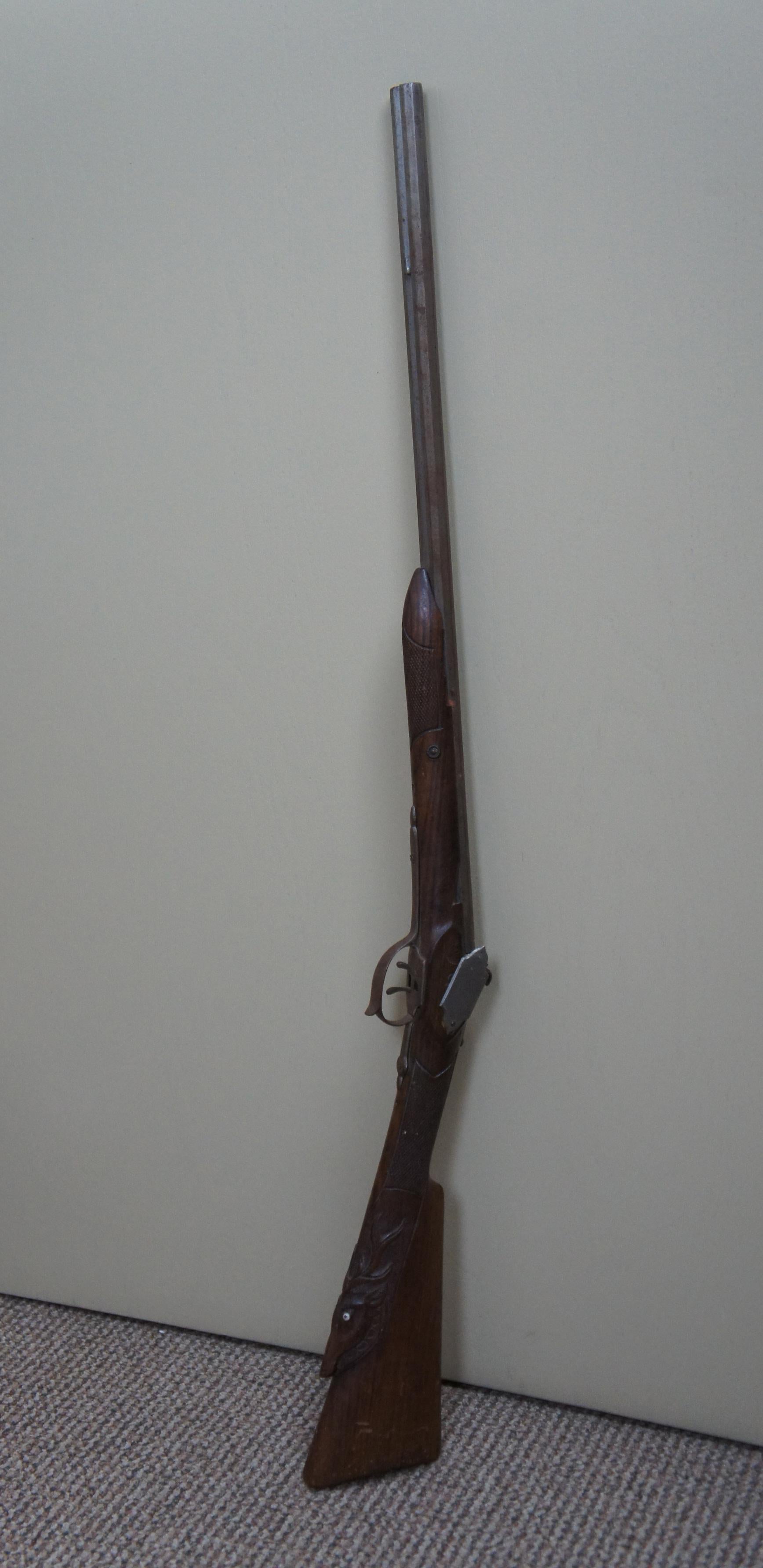 This double barrel shotgun is marked Brevete C.D.G. Brevete in French means patented. C.D.G stands for Charles de Gaullea French general and statesman. He was the leader of Free France and the head of the Provisional Government of the French