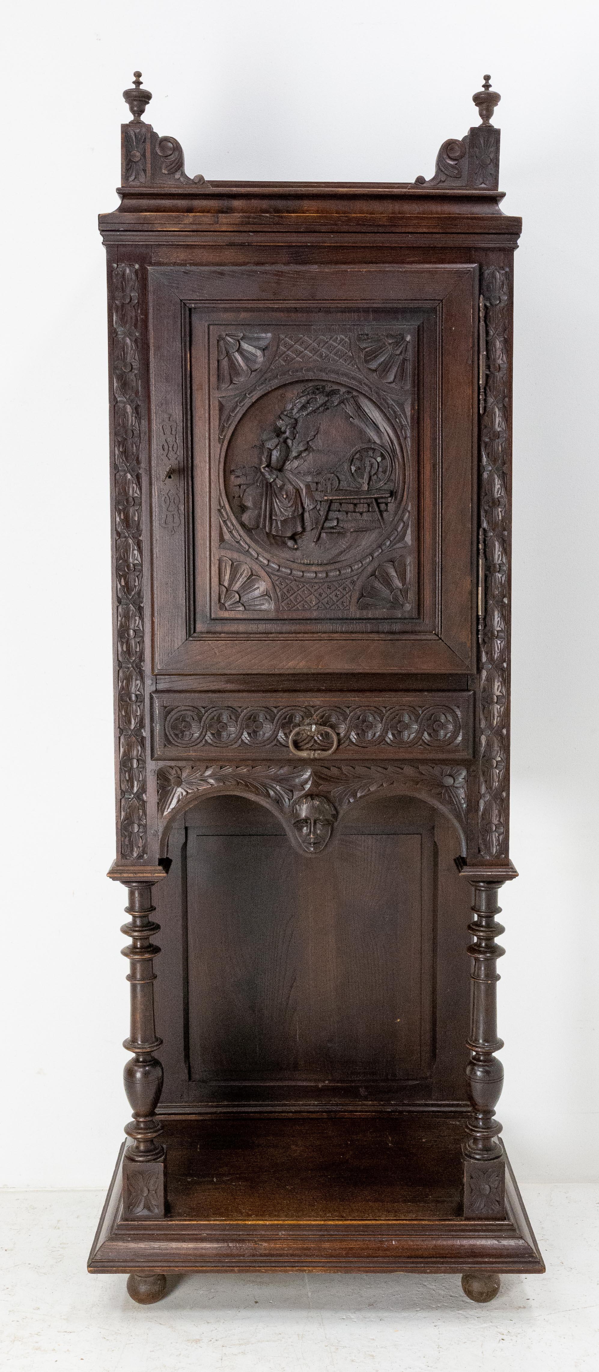 Buffet dressoir French cabinet, circa 1880
One carved door representing a woman spinning wool and one drawer.
Florals motifs on the front and one the sides of the cabinet
Massive chestnut
Nice patina
Good antique condition

Shipping: 
L65
