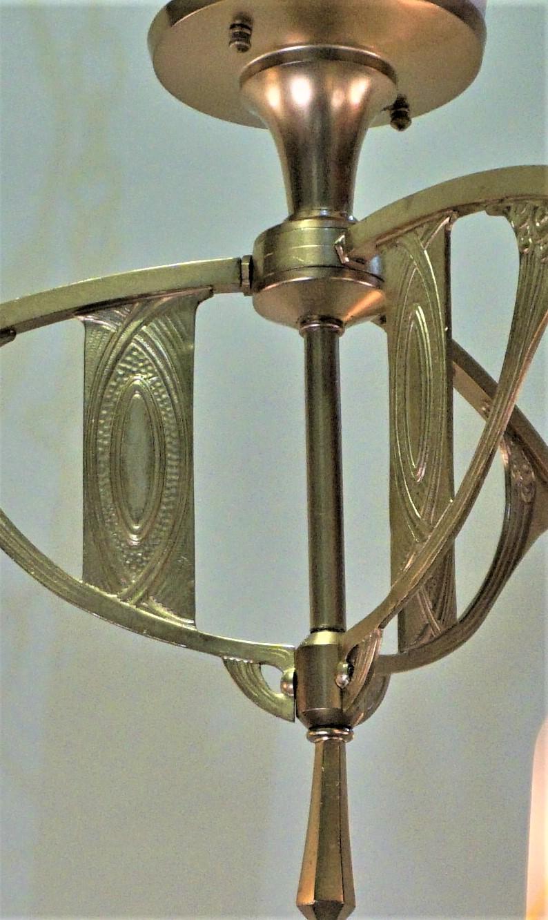 An elegant three-light bronze and art glass chandelier.