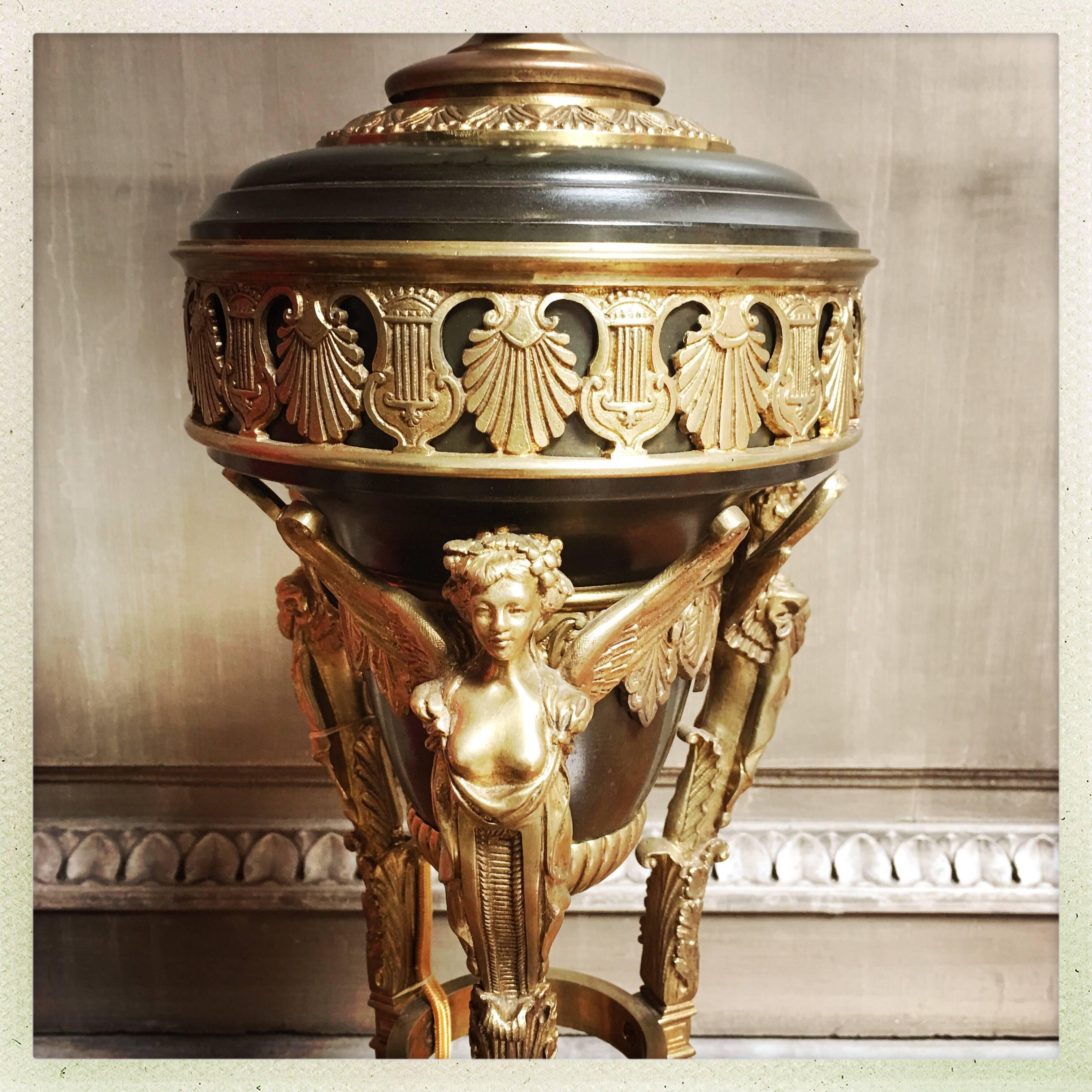 A French bronze 1st Empire style lamp base with winged figures.