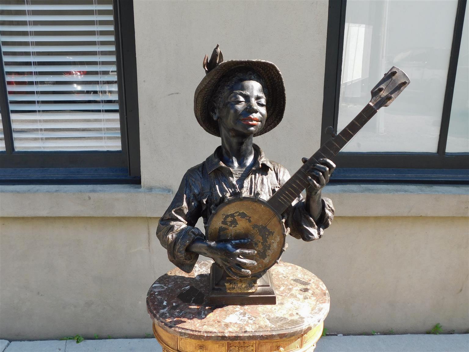 French Bronze Cold Painted African American boy playing banjo resting on squared molded plinth. 