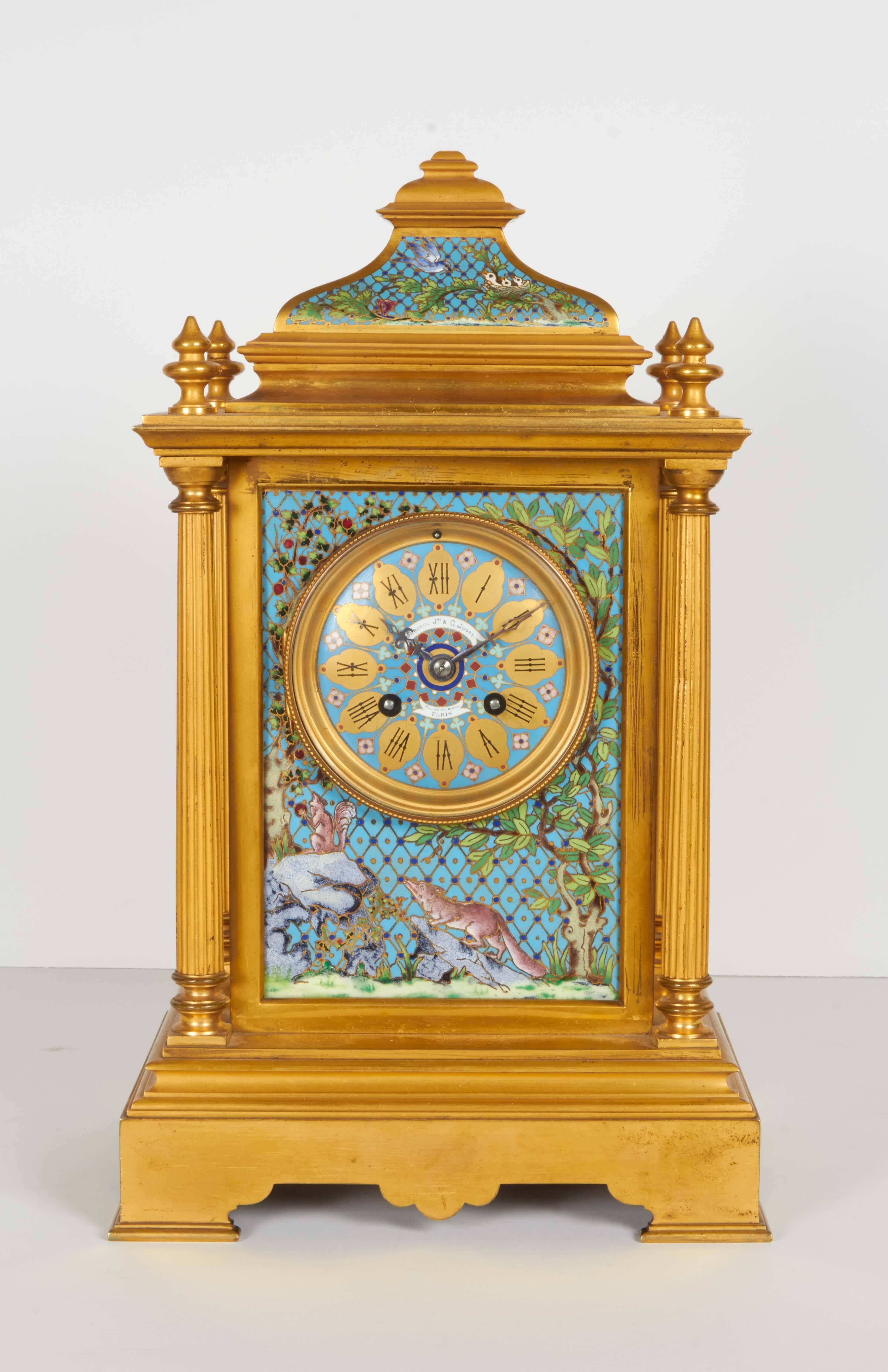 A magnificent and unusual French ormolu and cloisonne / champleve enamel clock garniture, comprising of five pieces, circa 1890.

A clock, a pair of vases and a pair of five-light candelabra finely decorated with brightly colored panels. The clock