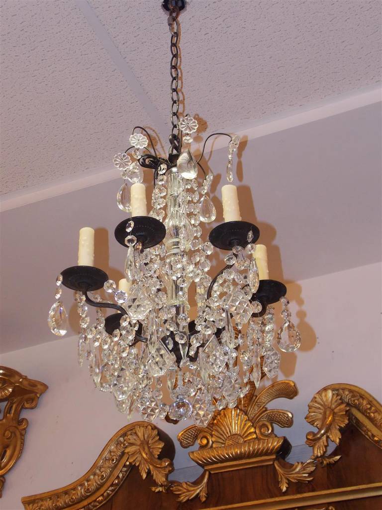 French bronze and crystal six light chandelier with a crystal bulbous column, and faceted crystal ball. Mid-19th century. Originally candle powered and has been electrified.