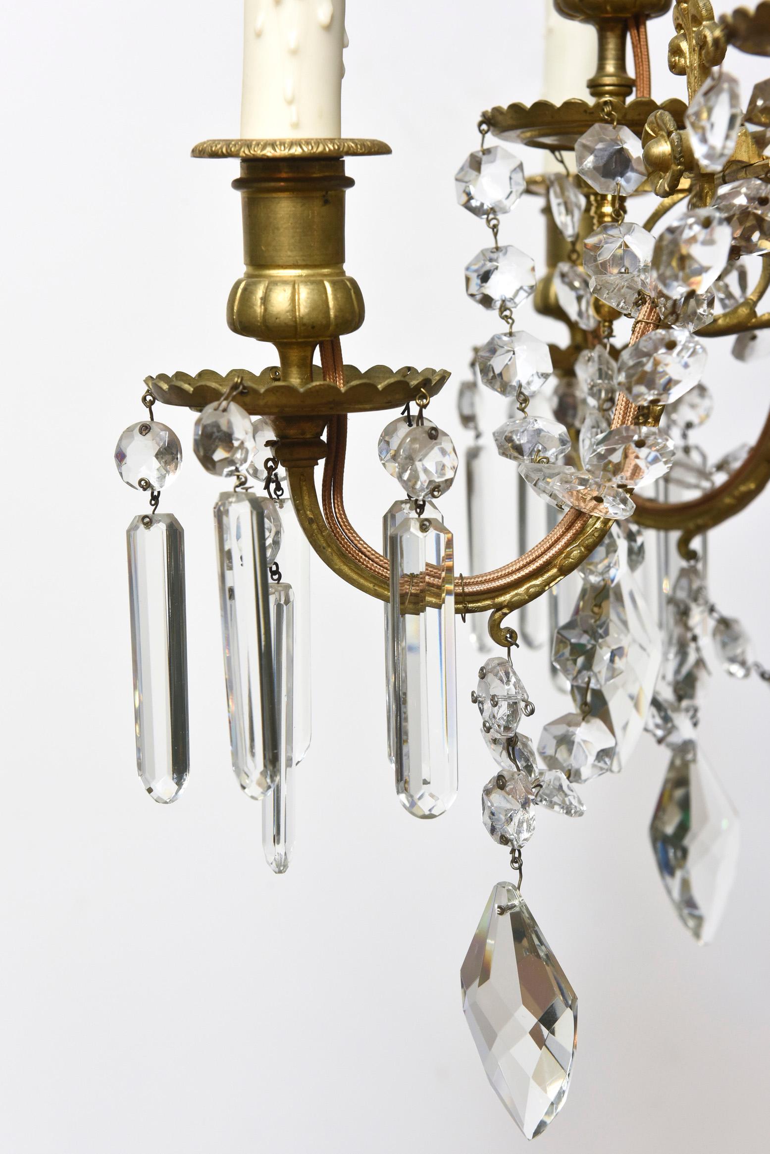 Twelve light gilt bronze and crystal chandelier, French, early 19th century. Unique Georgian and faceted diamond shaped crystals. Height is chandelier only. Completely restored with original patina, rewired and ready to hang. Originally for