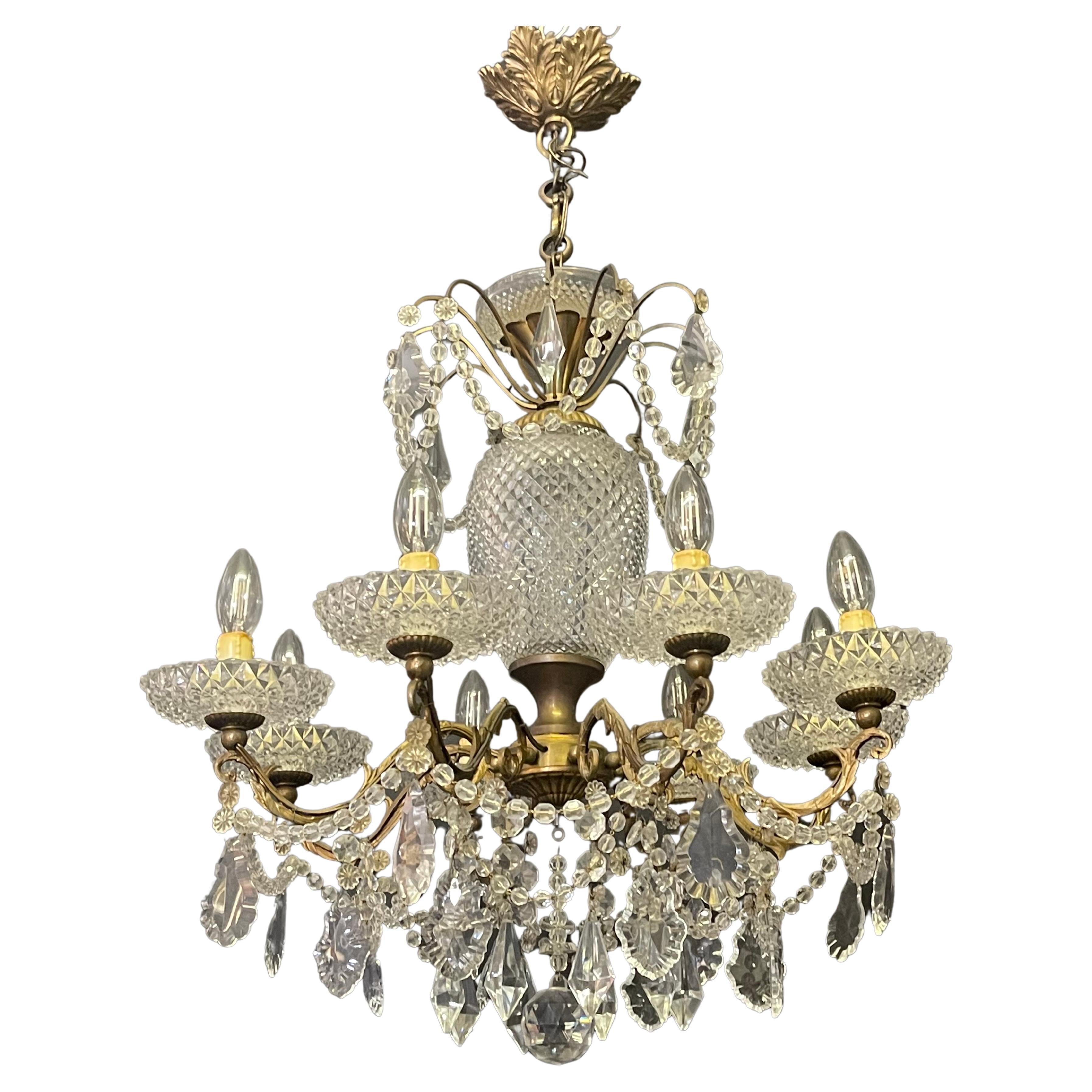 An Art Deco bronze and crystal chandelier, France, circa 1940s.
A wonderful hand-crafted eight-light chandelier decorated with diamond cut crystal and many crystal pendants.
Socket: 8 x e14 for standard screw bulbs.

In an excellent condition.