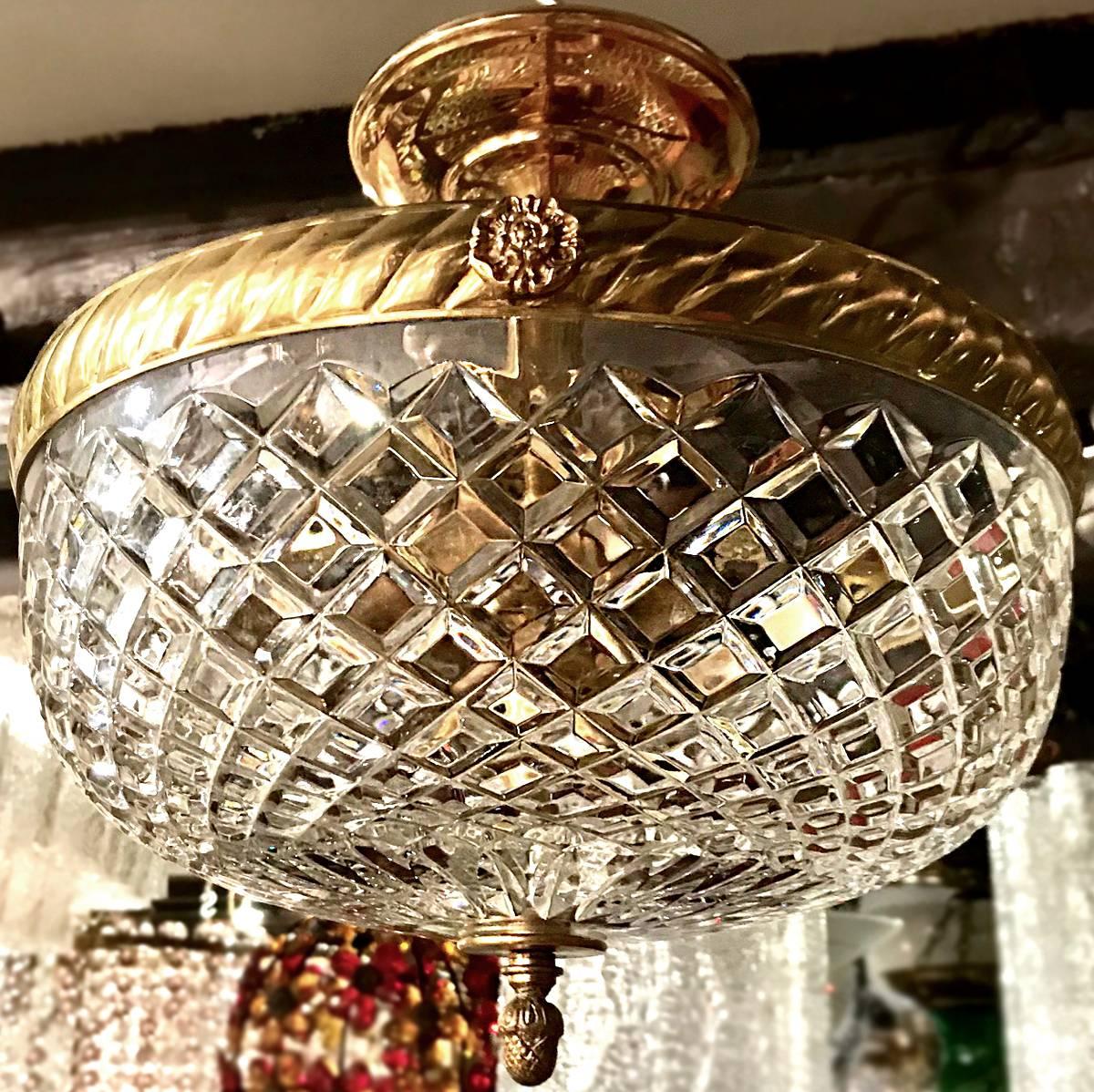A French circa 1940's gilt bronze and cut glass low-drop fixture with interior lights.
Measurement:
Diameter 12.25