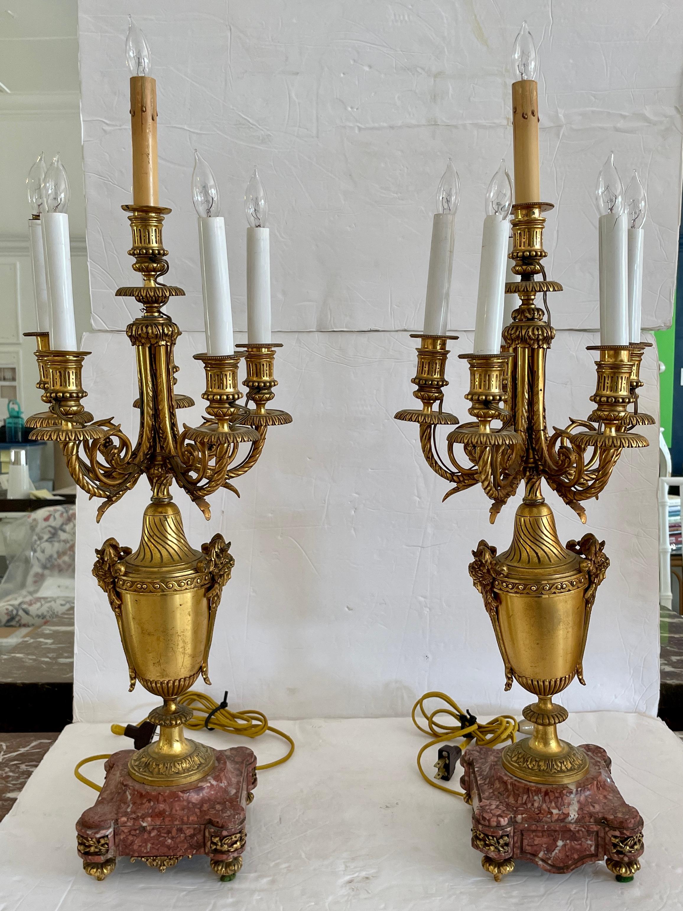 Beautiful pair of French bronze and marble base urns candelabra table lamps with original finish. Very elegant shape and size. Add some French style to your home.