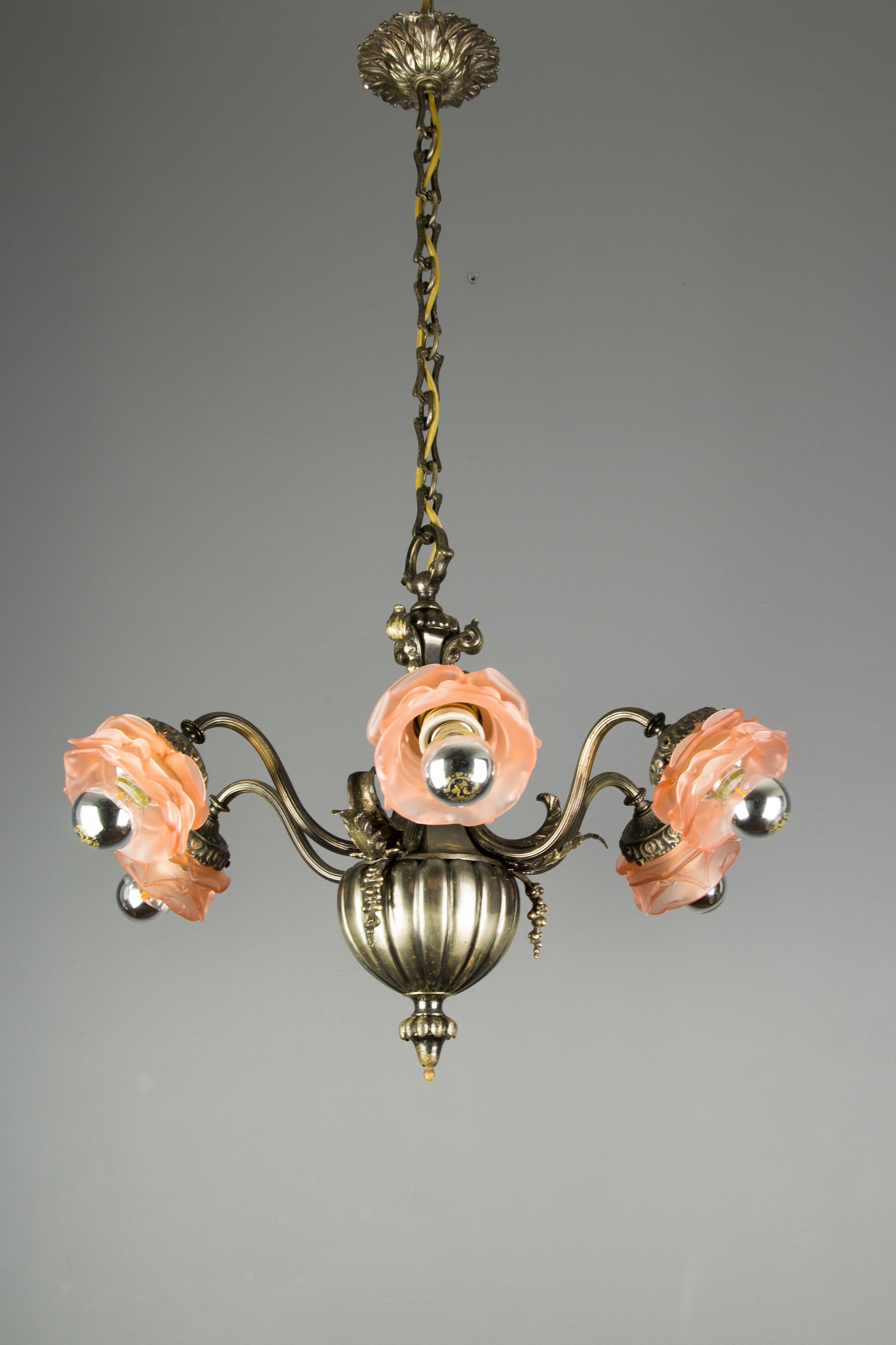 Beautiful silver color bronze and brass six-arm chandelier, each arm with pink floral-shaped frosted glass shade with one socket for E27 size light bulb. France, 1920s.
Dimensions: diameter 55 cm / 21.65 in; height 80 cm / 31.49 in.
The light