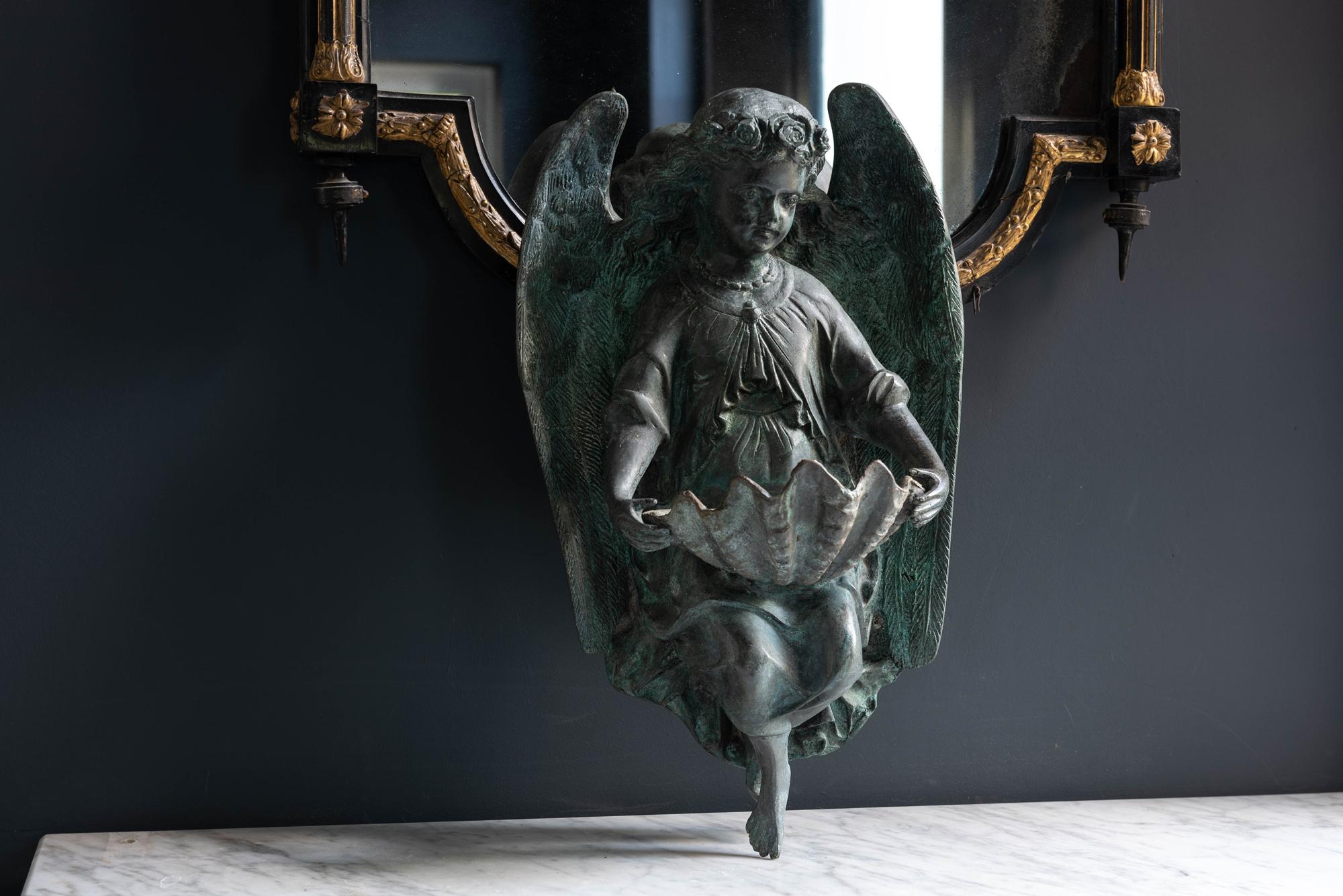 French bronze angel stoup after Dumaige, 1838, 19th century.
A beautiful large cast bronze angel wall hanging holding a large shell as a holy water stoup. Strong verdigris patination and in good condition
This is a later casting of Henry Etienne