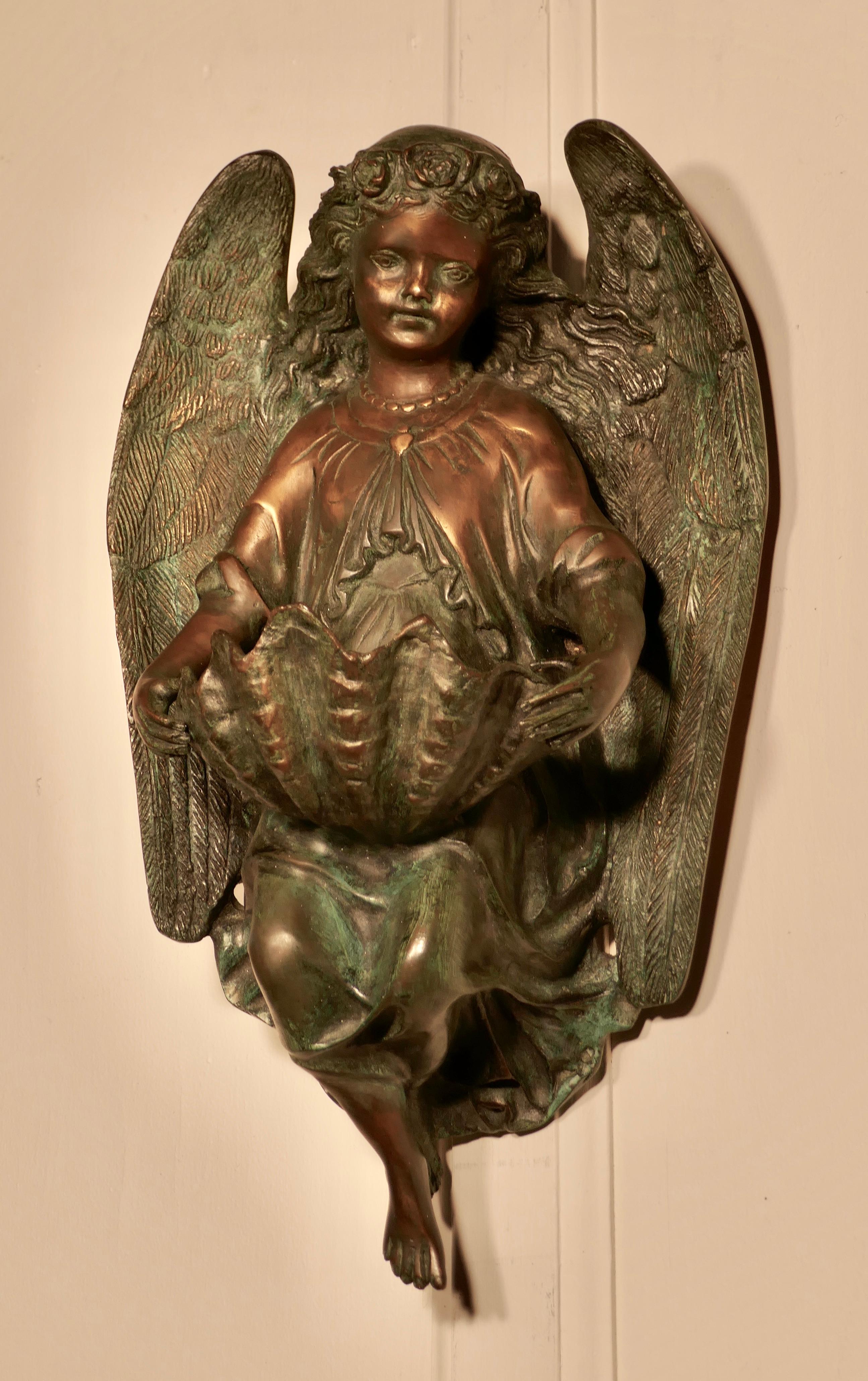 French bronze Angel, wall plaque after Dumaige, 1838

A beautiful large cast bronze wall hanging, a charming angel with long flowing curls holding a large shell as a holy water stoup, this casting is in very fine detail 

The bronze is signed on