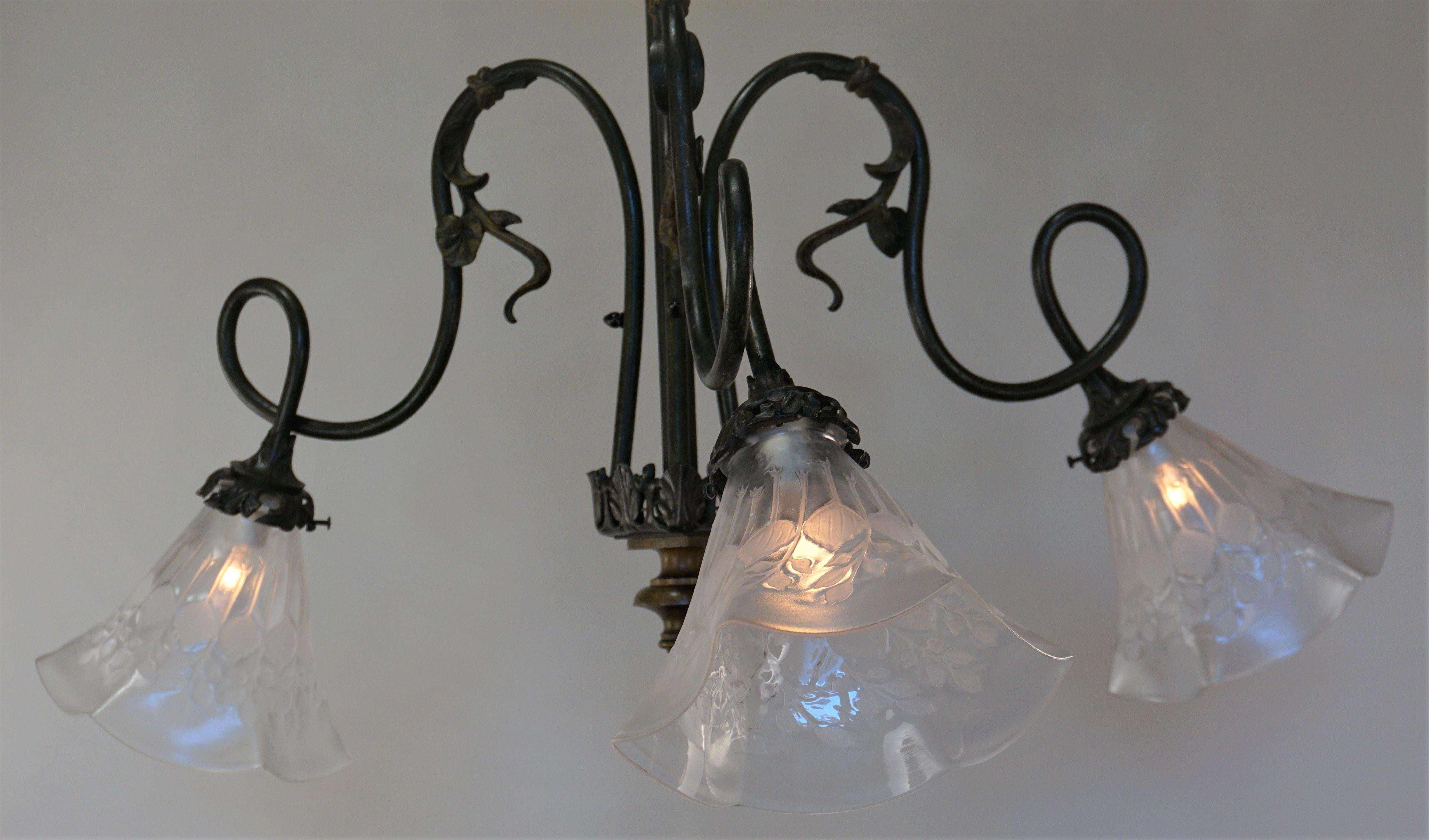 French three-light Art Nouveau bronze chandelier with large etched glass clear Frost shades.