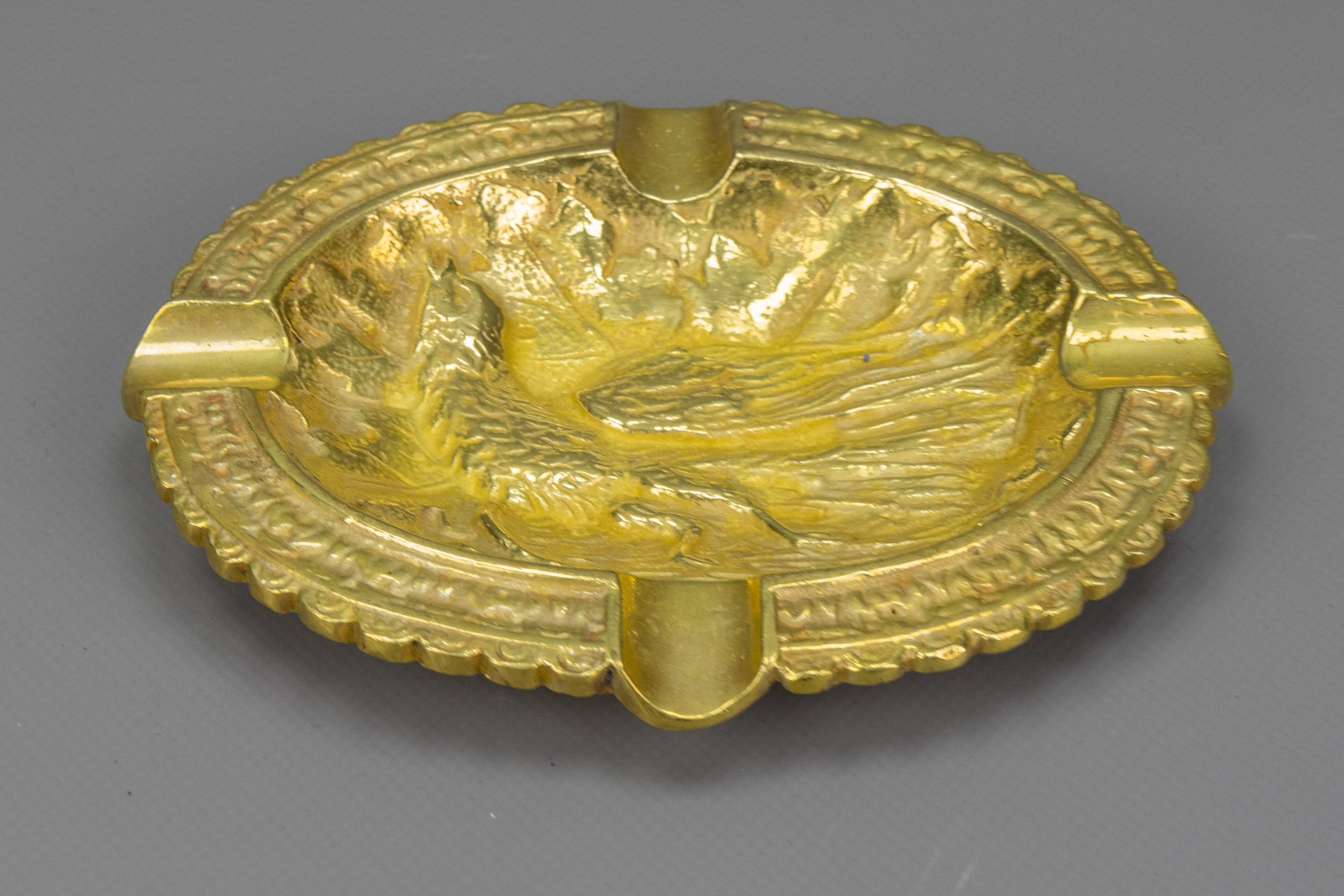 Vintage French bronze ashtray featuring a beautifully embossed phoenix bird.

A charming mid-20th-century French bronze ashtray, circa 1950s, richly decorated with a detailed relief of a phoenix bird surrounded by stylised foliage. The oval form,