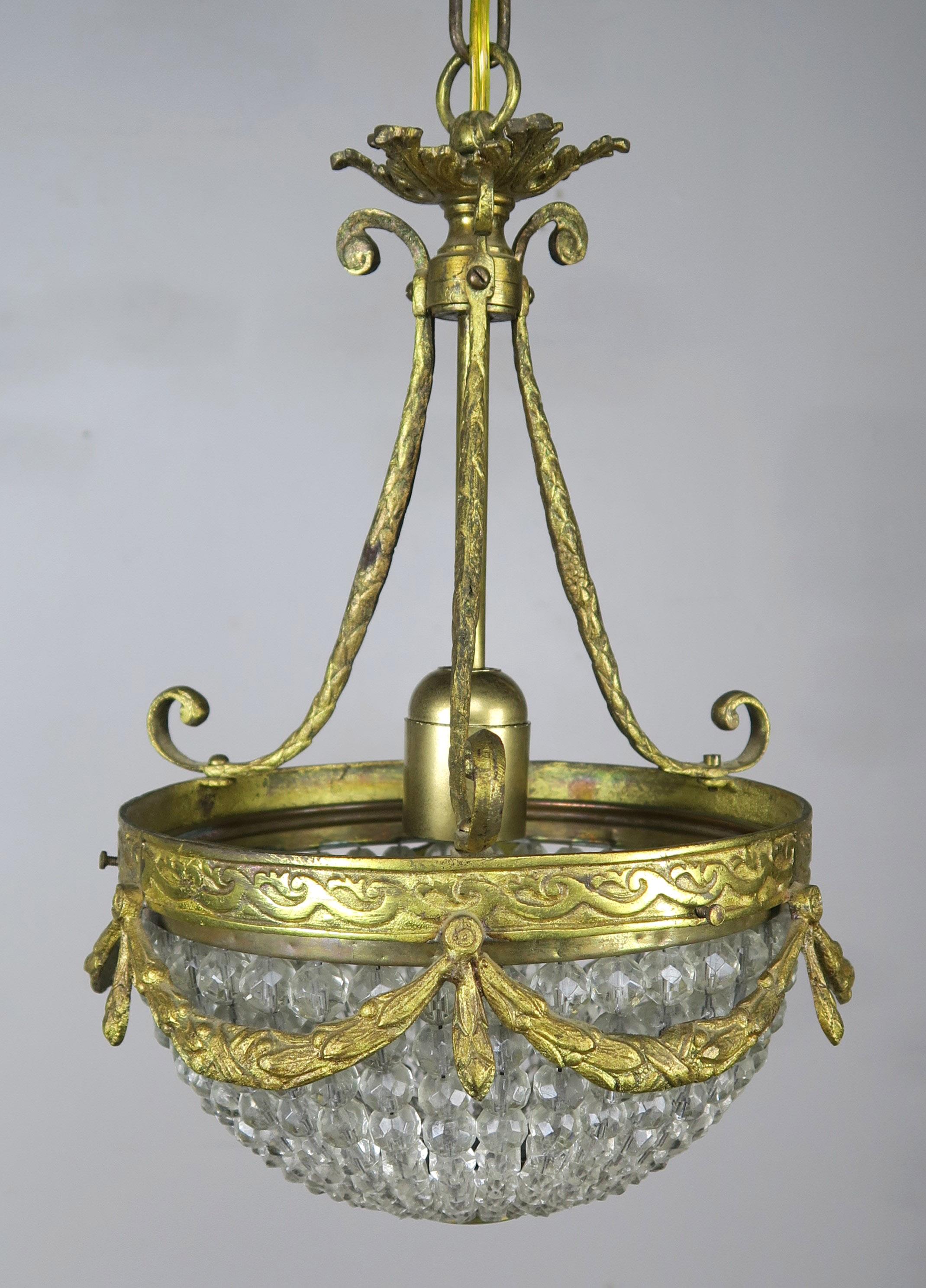 French bronze and beaded ceiling fixture with bronze garlands swaging around the perimeter of the beading. The fixture is newly rewired and includes chain and canopy.