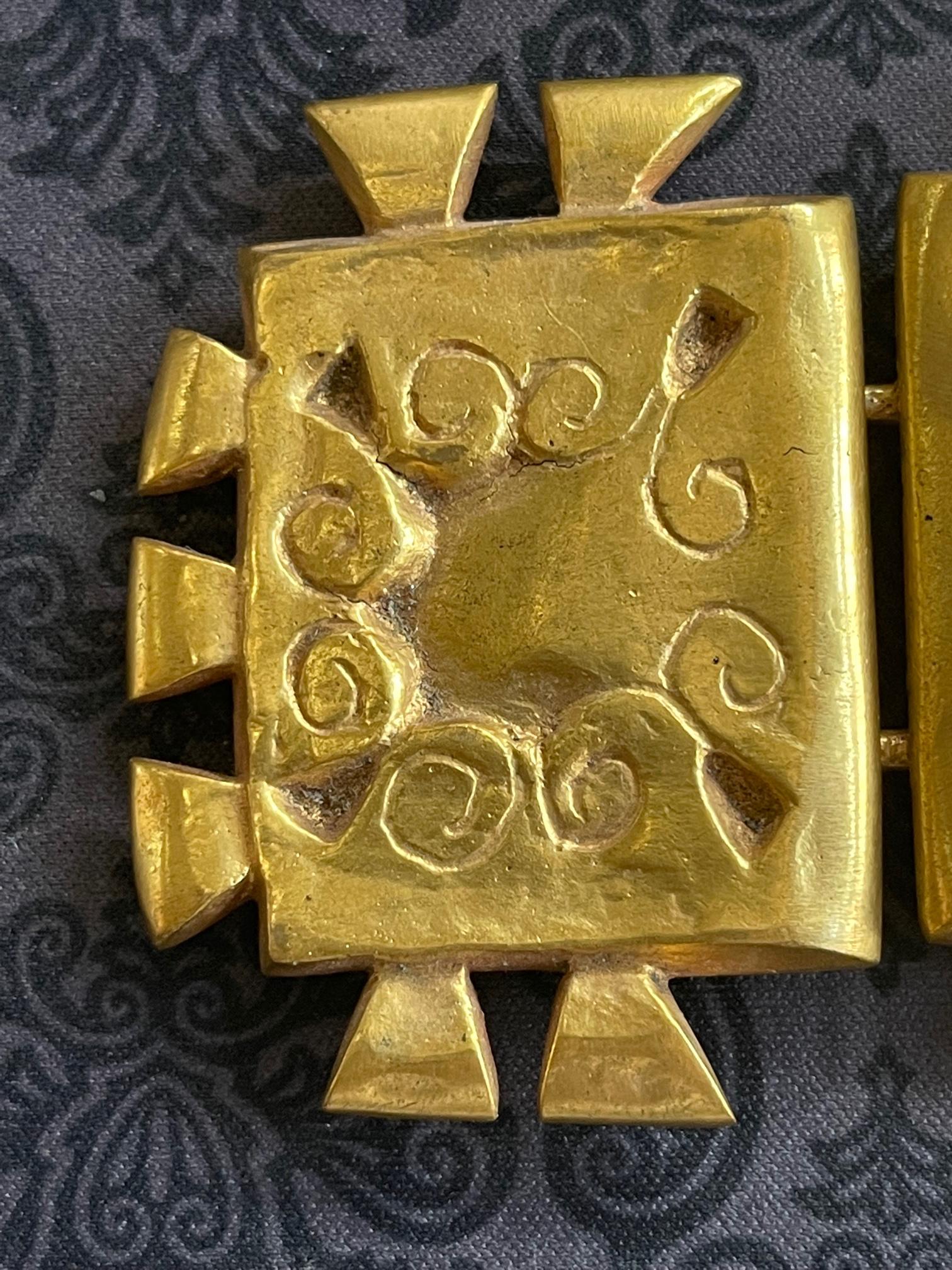 A cast bronze two-piece bronze buckle with hook and loop verso by French art jeweler Line Vautrin (1913-1997). The sculptural pieces are In a rare Inca motif, with triangular indentation in contrast with scrolling lines and wedge-shape protrusions