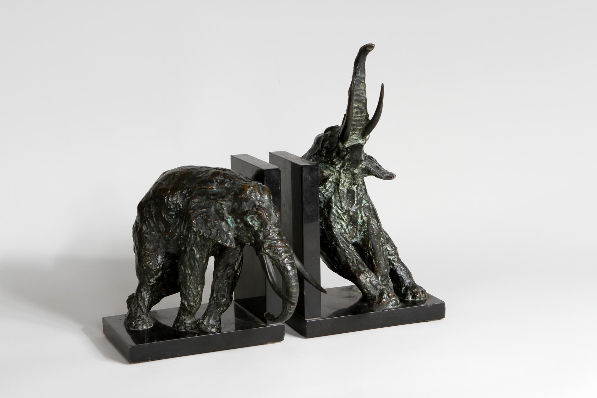 Pair of patinated bronze bookends with black marble base representing two elephants by french artist Ary Bitter, founder Susse frères, stamped on the side. 

Incredible and massive piece representing perfectly the movement of the artist. The piece