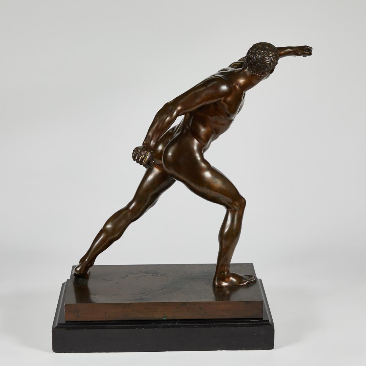 Dynamic French 19th-century bronze sculpture of a Greek warrior in action. An exquisitely naturalistic rendering of an athletic physique, the figure is dramatically caught in action.  The sculpture is mounted on a black marble fitted base. 

France,
