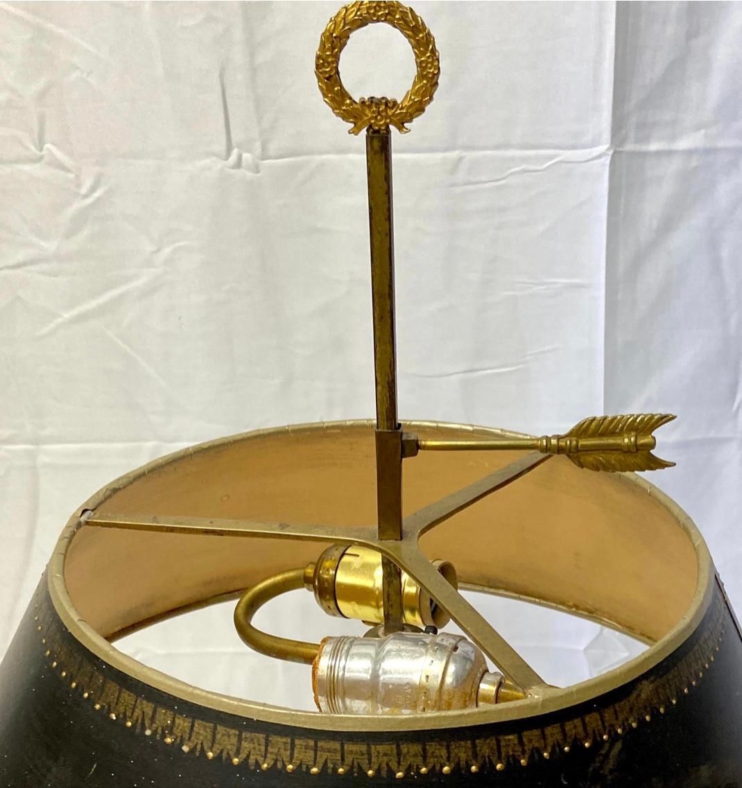 Beautiful French bronze Bouillote lamp with black matte and gold trim shade. Lamp features two light sockets and two candles brackets. Very good condition appropriate to age.