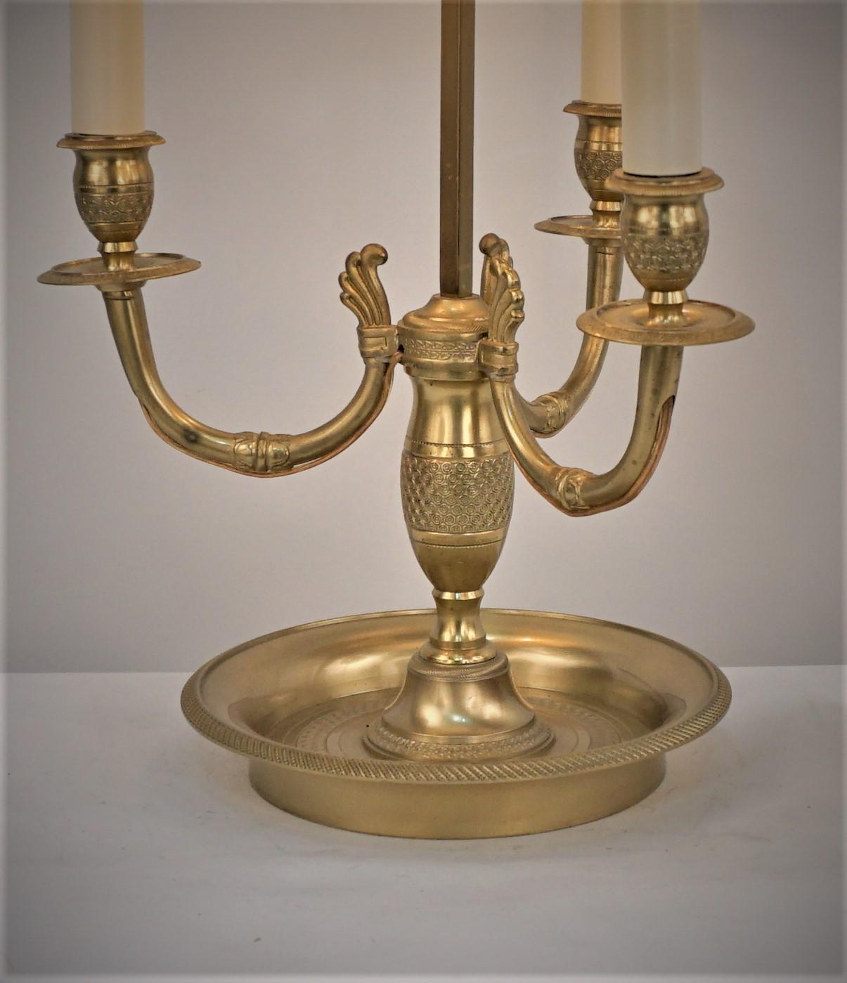 Elegant three light circle 1900 bouillotte table lamp with adjustable shade.