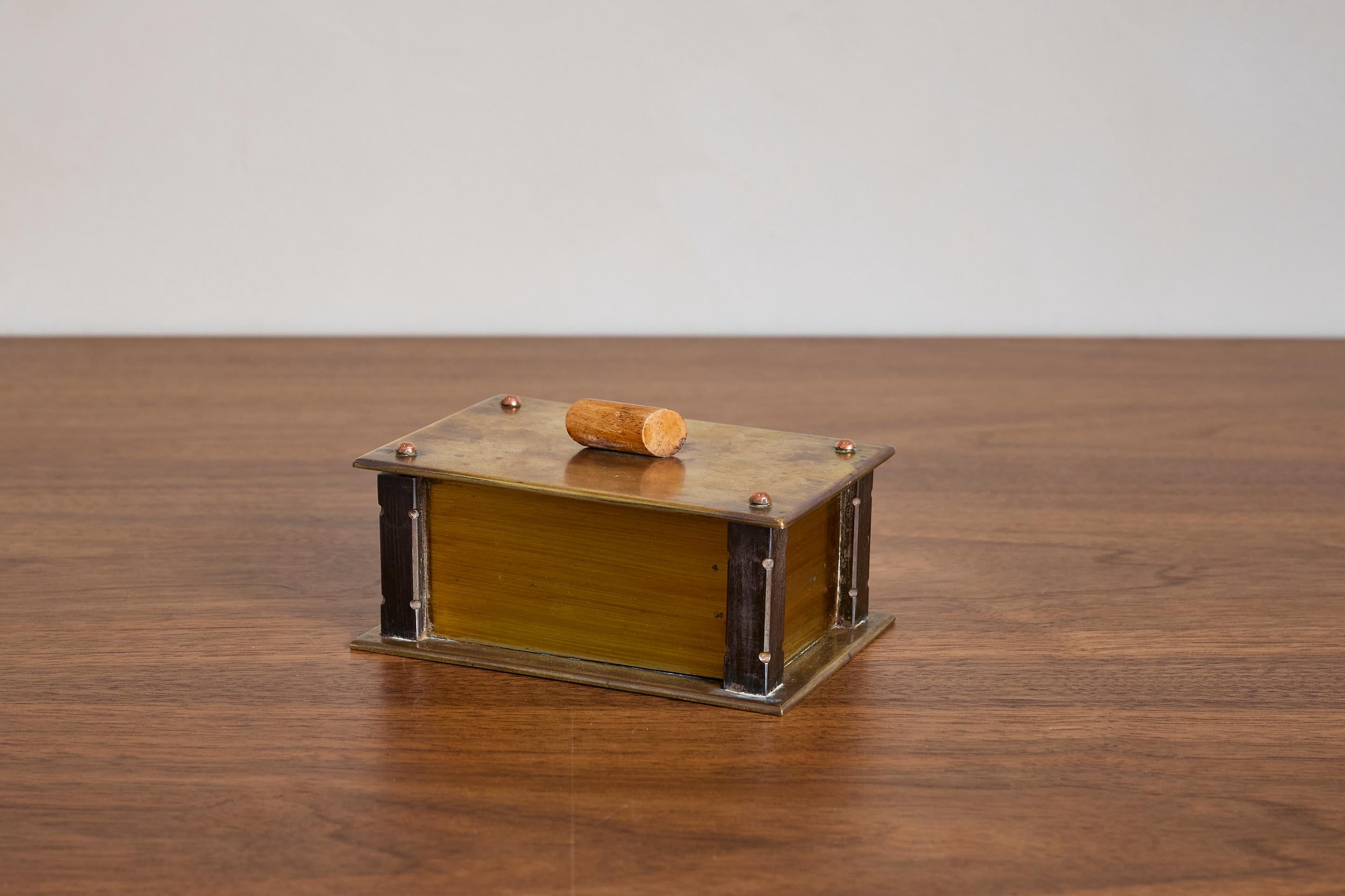 Handsome petite solid bronze box with wooden cylinder handle and corner detail 

France 1950's